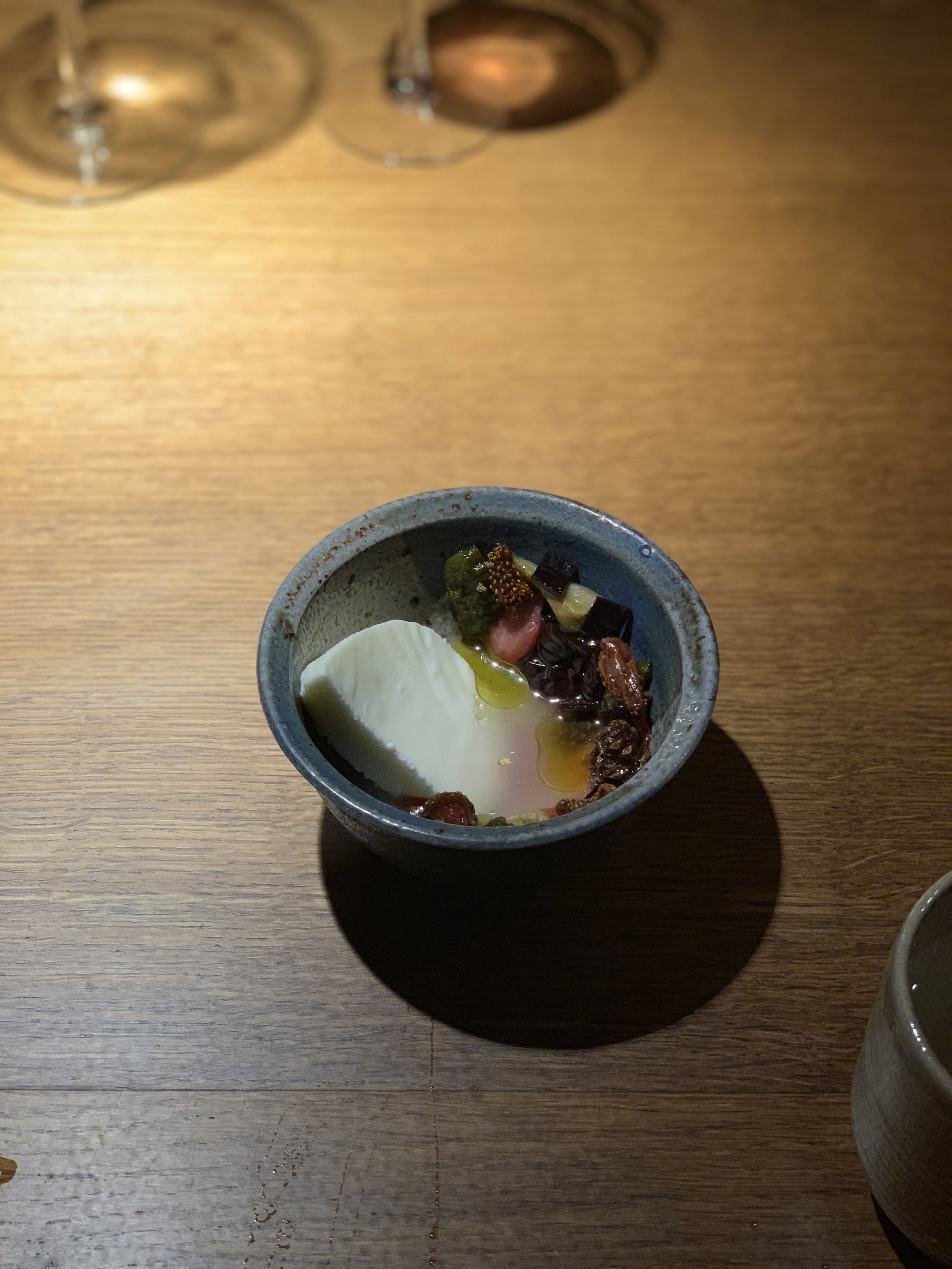  For dessert: A mousse with sheep’s milk yogurt with salted berries from the previous summer, pickled pine cones, and seaweed marinated in Arronia berry. Everything was in a white currant broth. 