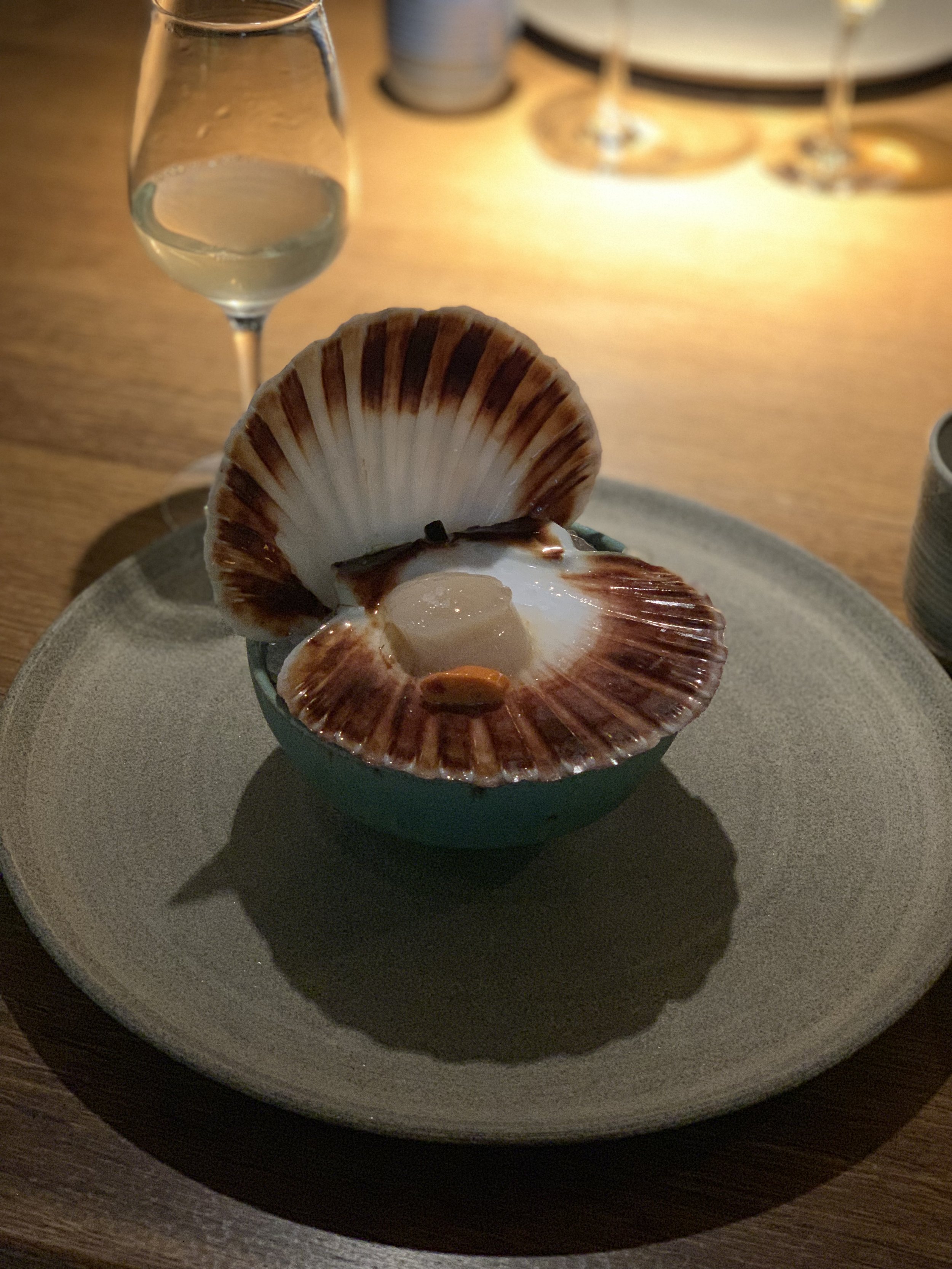  Scallop still attached to the shell with its own roe. We used the scallop’s flat shell to scrape the meat off the shell and into our mouths! 