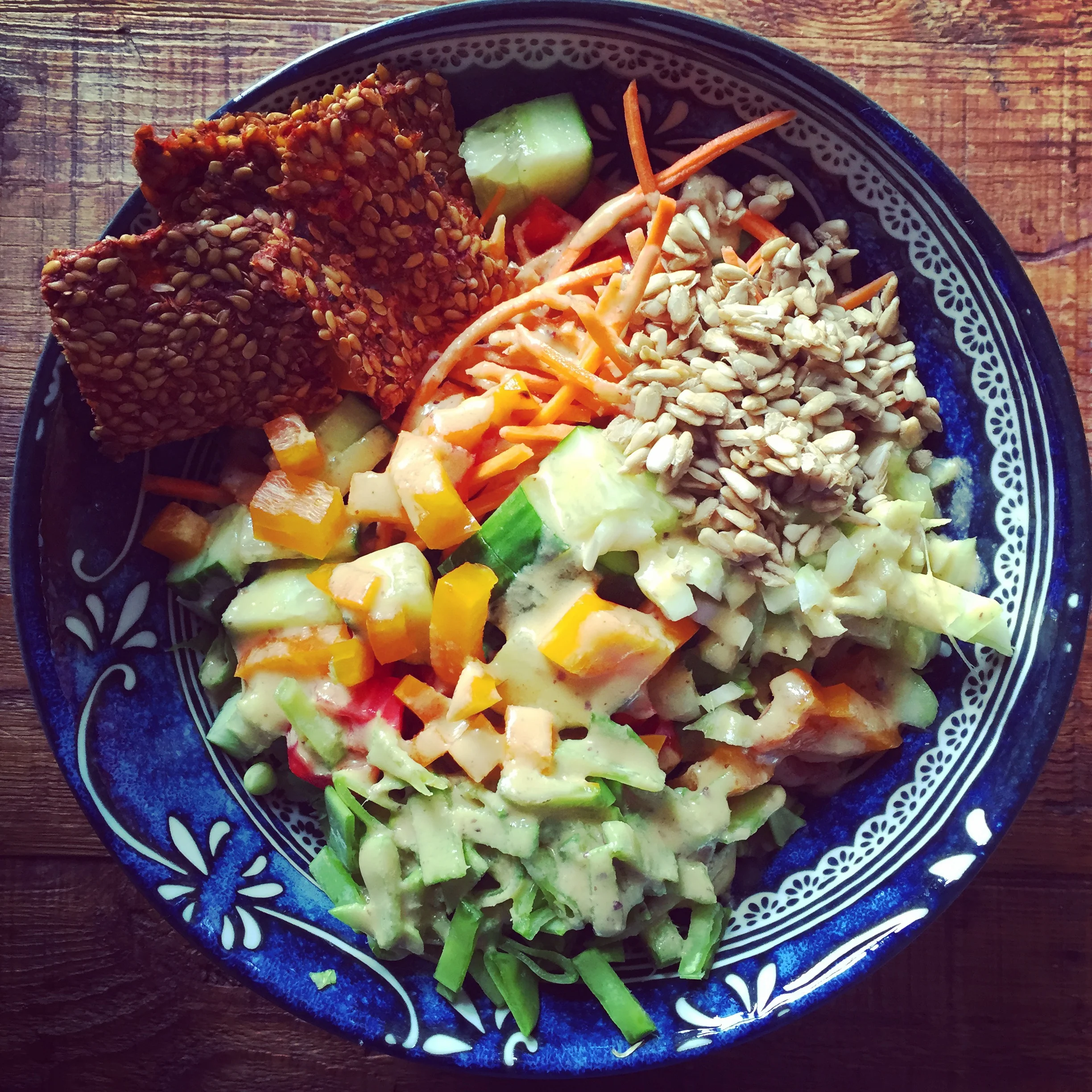 Chopped salad with pizza crackers and caesar dressing. 