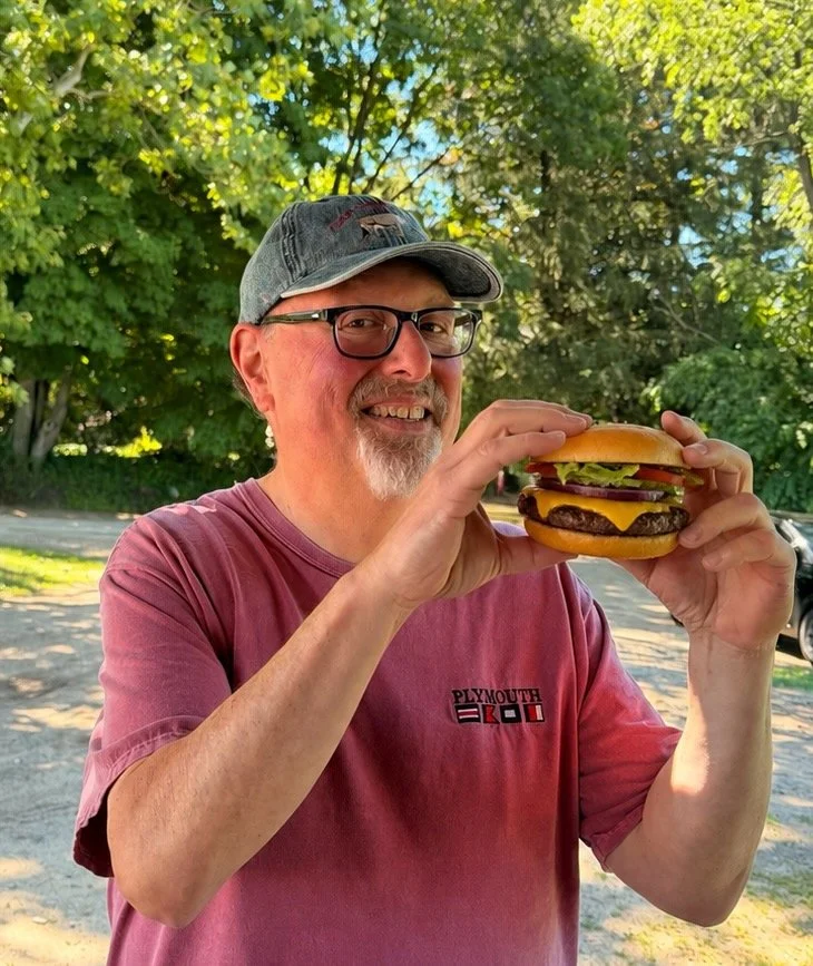 adam with burger.jpeg