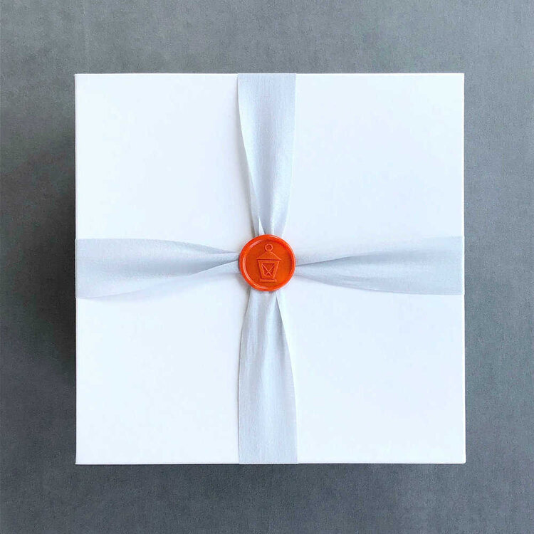 White and orange wrapped corporate gift box