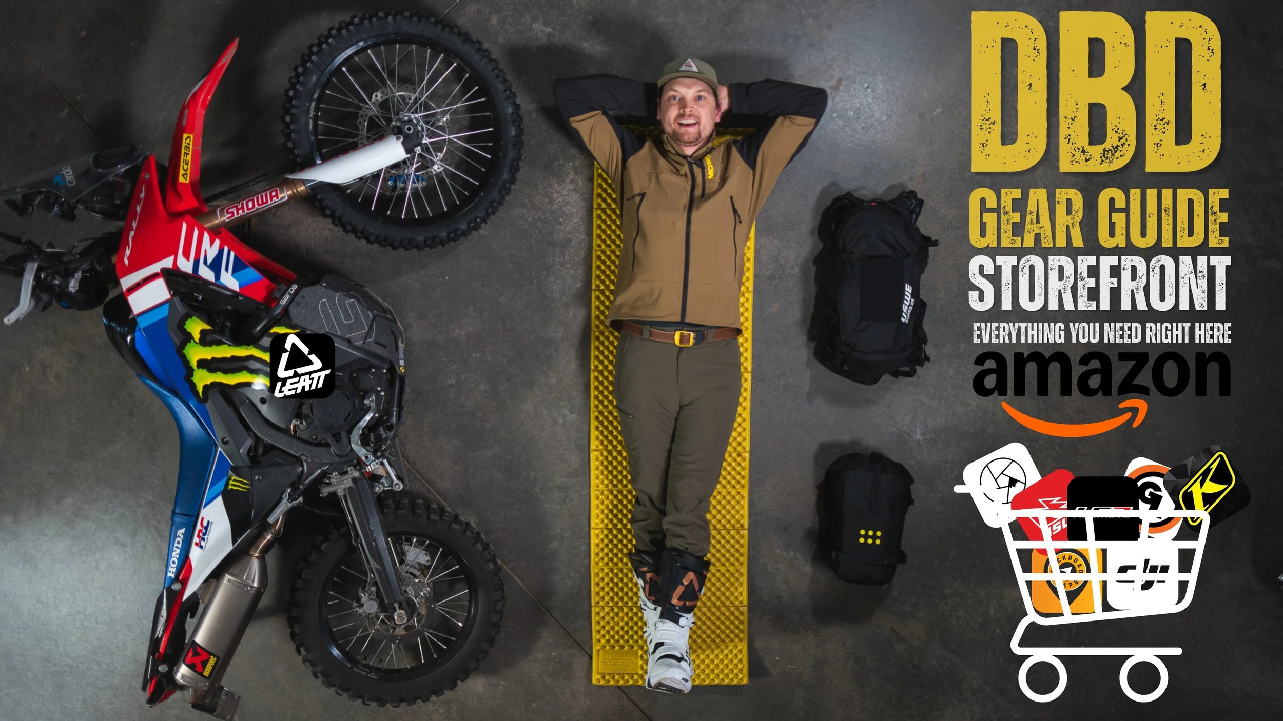A man lying on a yellow foam mat, surrounded by motorcycle gear and accessories, with a dirt bike on the left and a shopping cart graphic filled with gear on the right, along with text promoting a gear guide on Amazon.