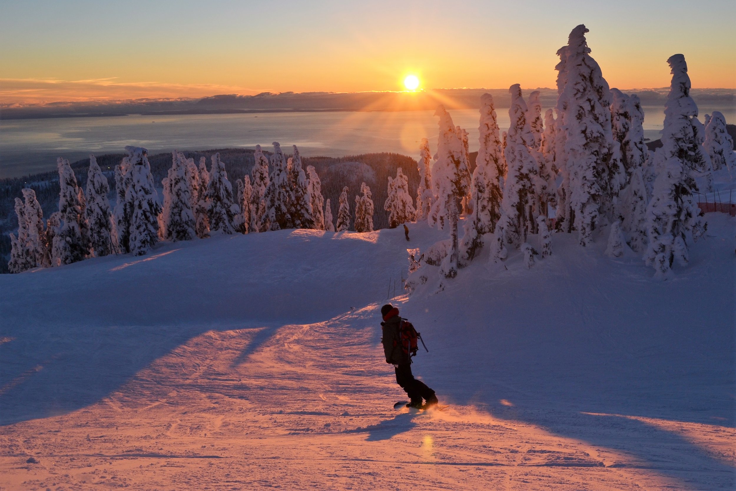 Snowboarder enjoying a late afternoon run in Vancouver