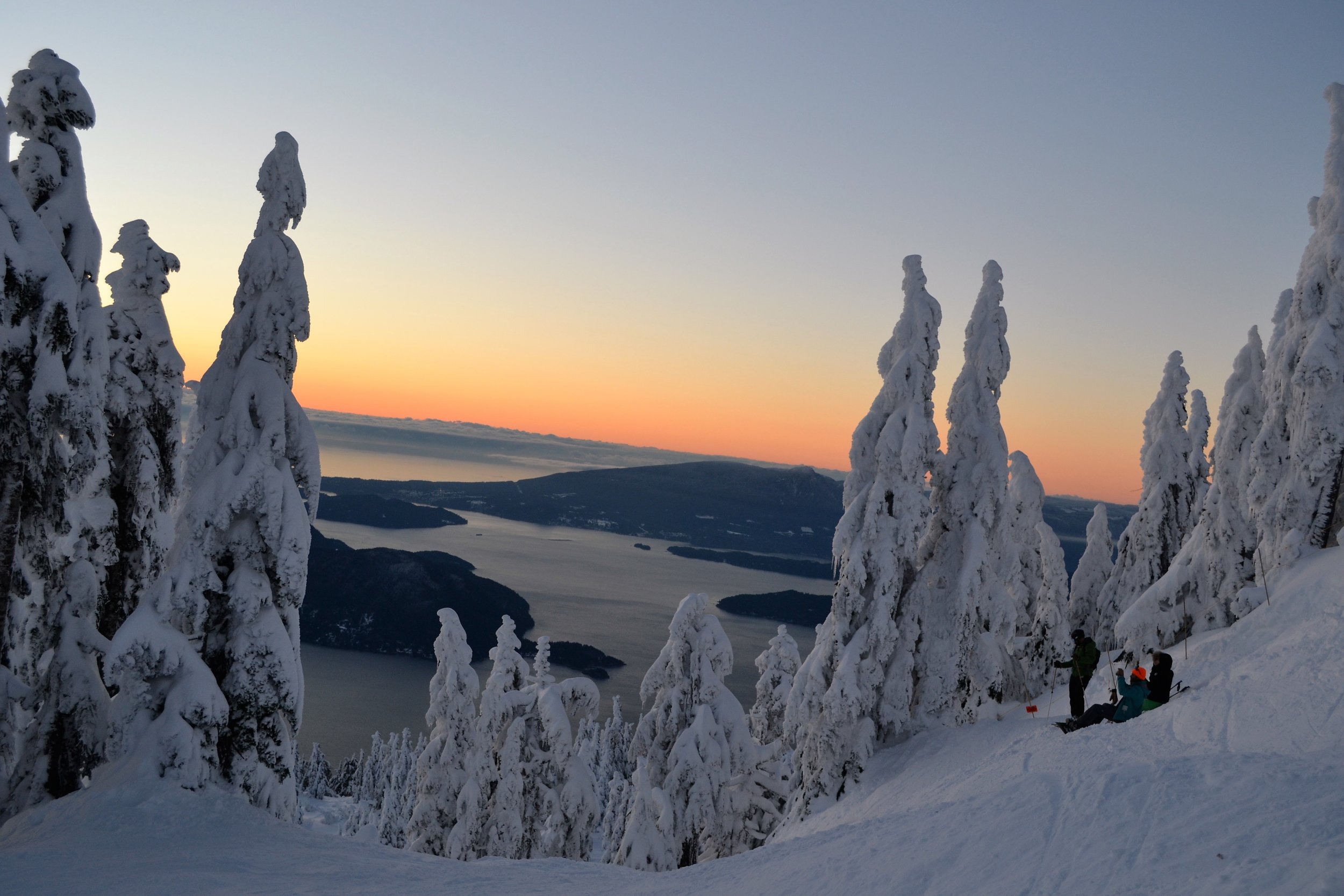Snowboarders relaxing during sunset in Vancouver