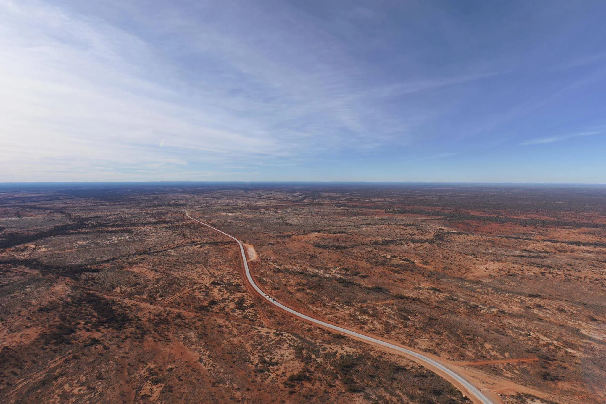 View over the Western Desert from the comfort of a helicopter with its door removed. Photo copyright Kate Ferguson. 