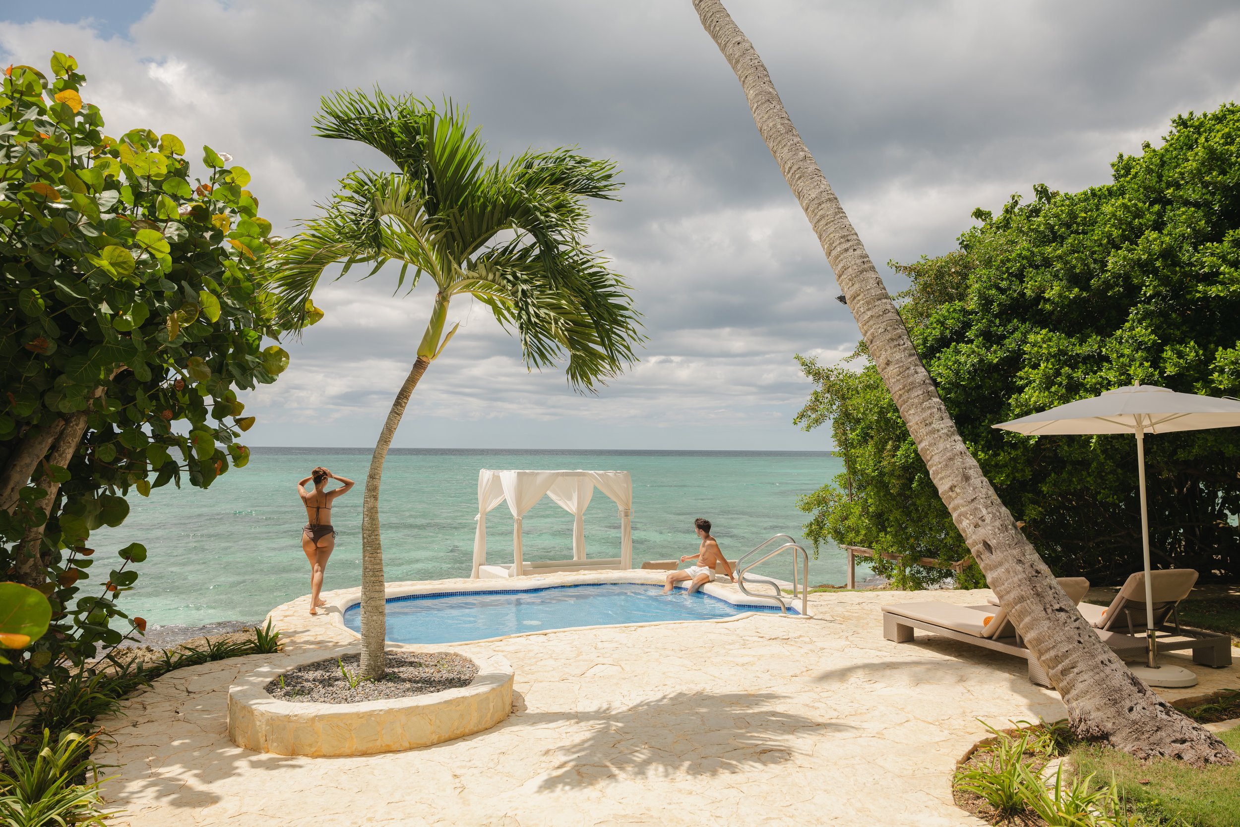 Guests relaxing on private beach island at luxury Caribbean resort, David McConaghy Photography