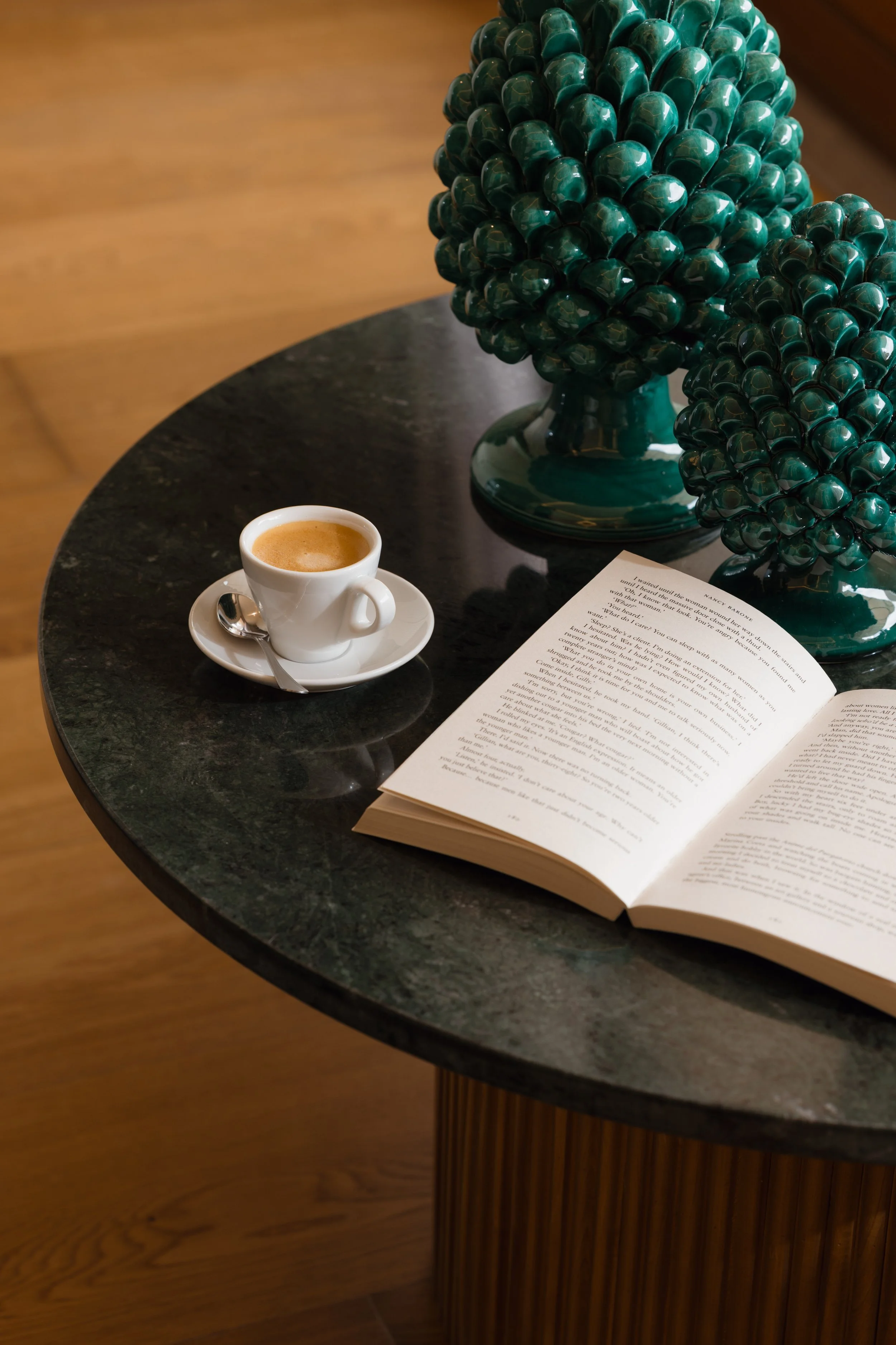 Espresso and open book on marble table in luxury hotel, lifestyle detail photography by David McConaghy