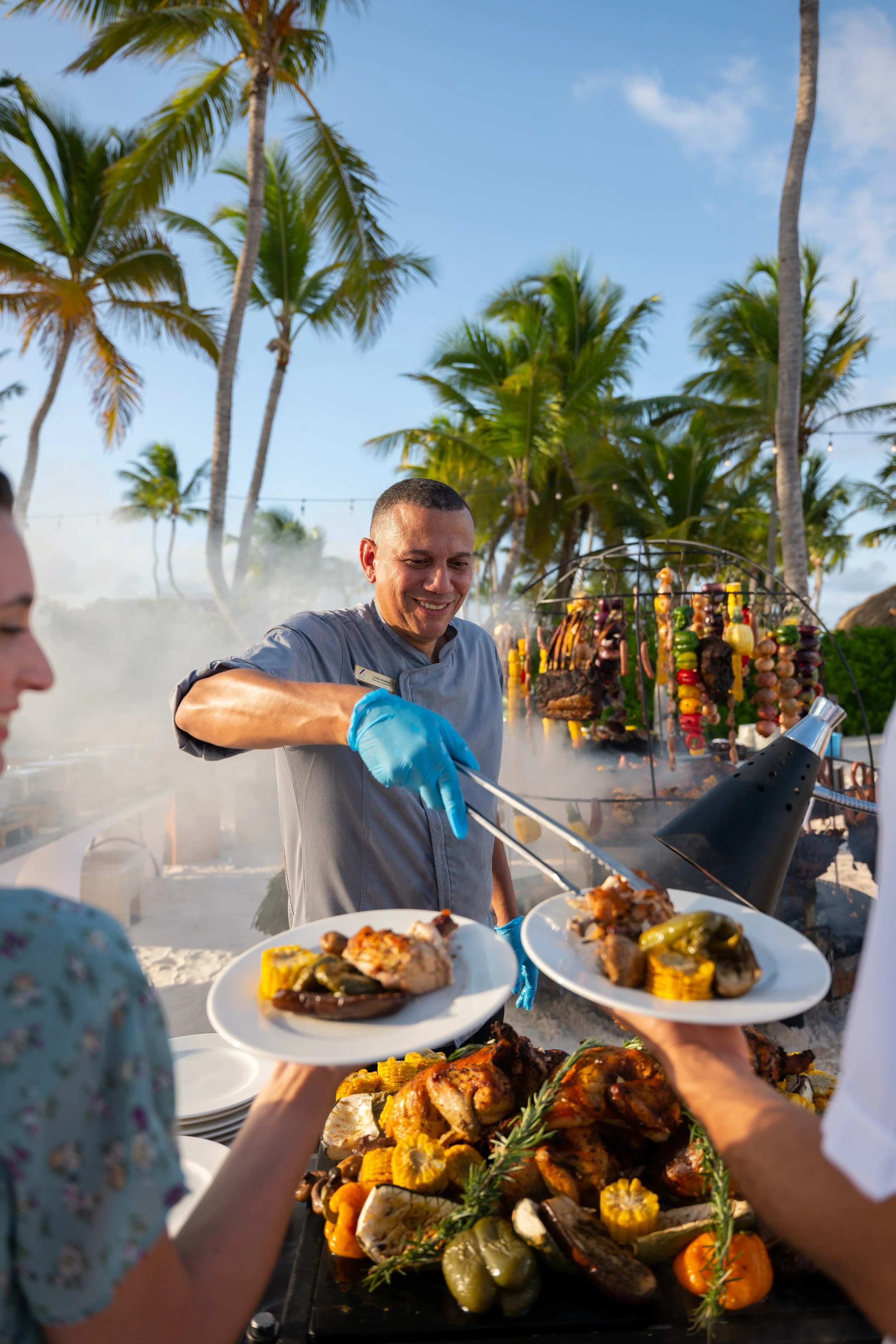 Chef serving grilled food at outdoor beach restaurant, hotel food and beverage photography by David McConaghy