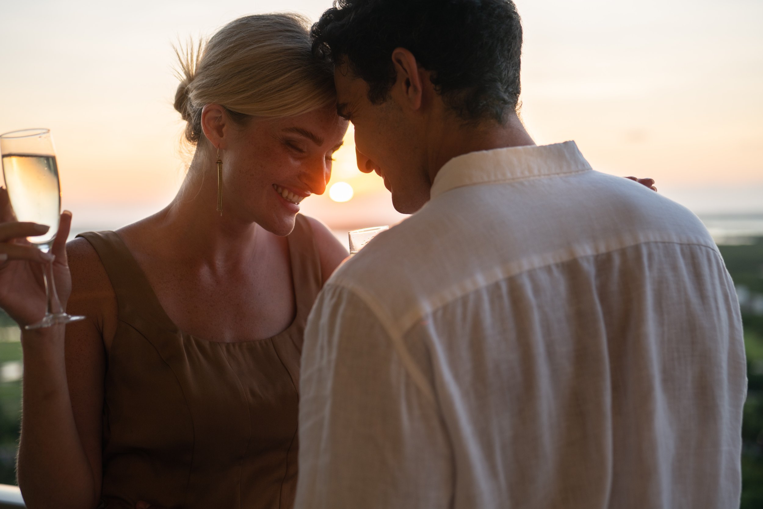 Romantic couple at golden hour sunset, luxury hotel lifestyle photography by David McConaghy