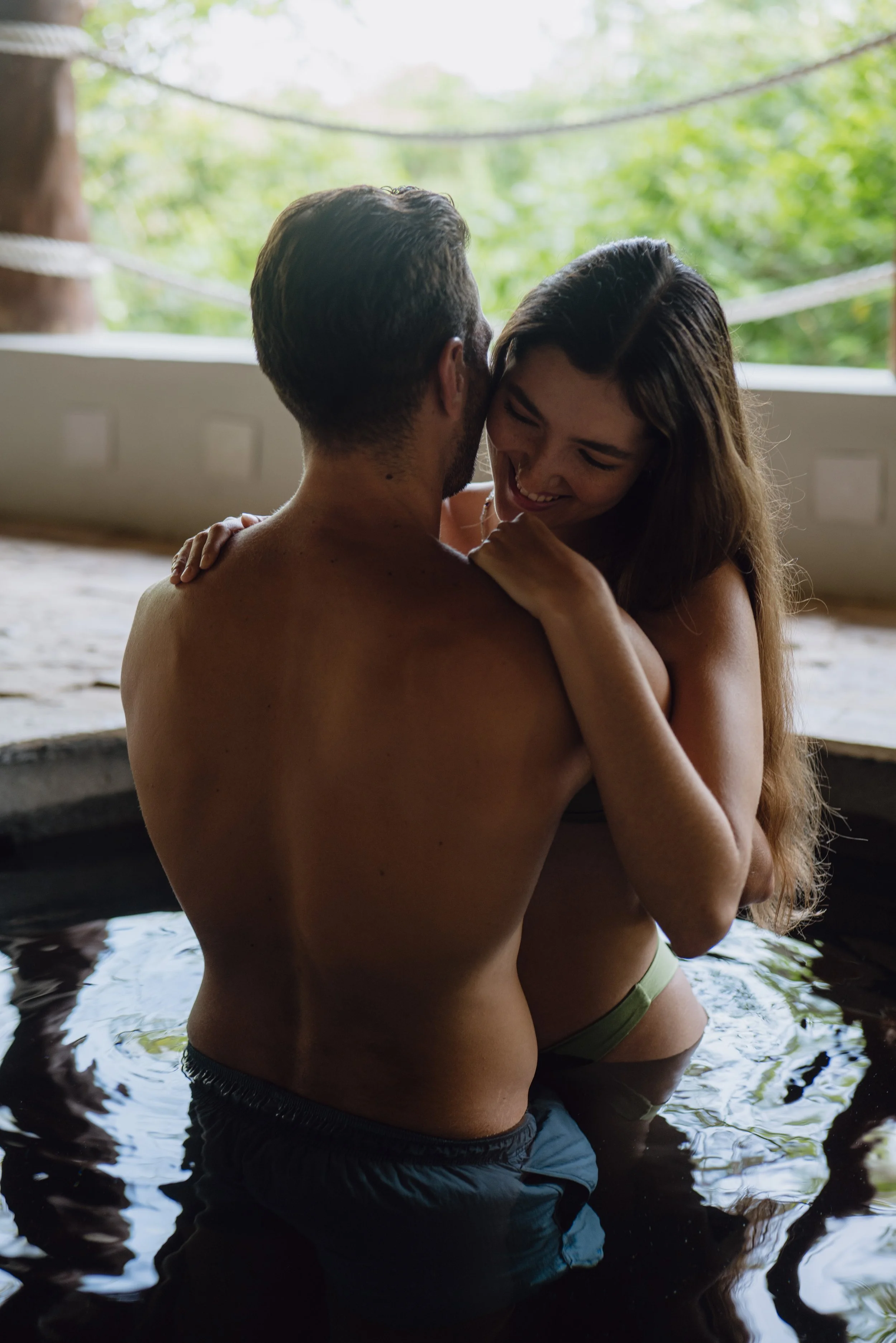 Couple in outdoor hot tub at luxury resort spa, wellness photography by David McConaghy