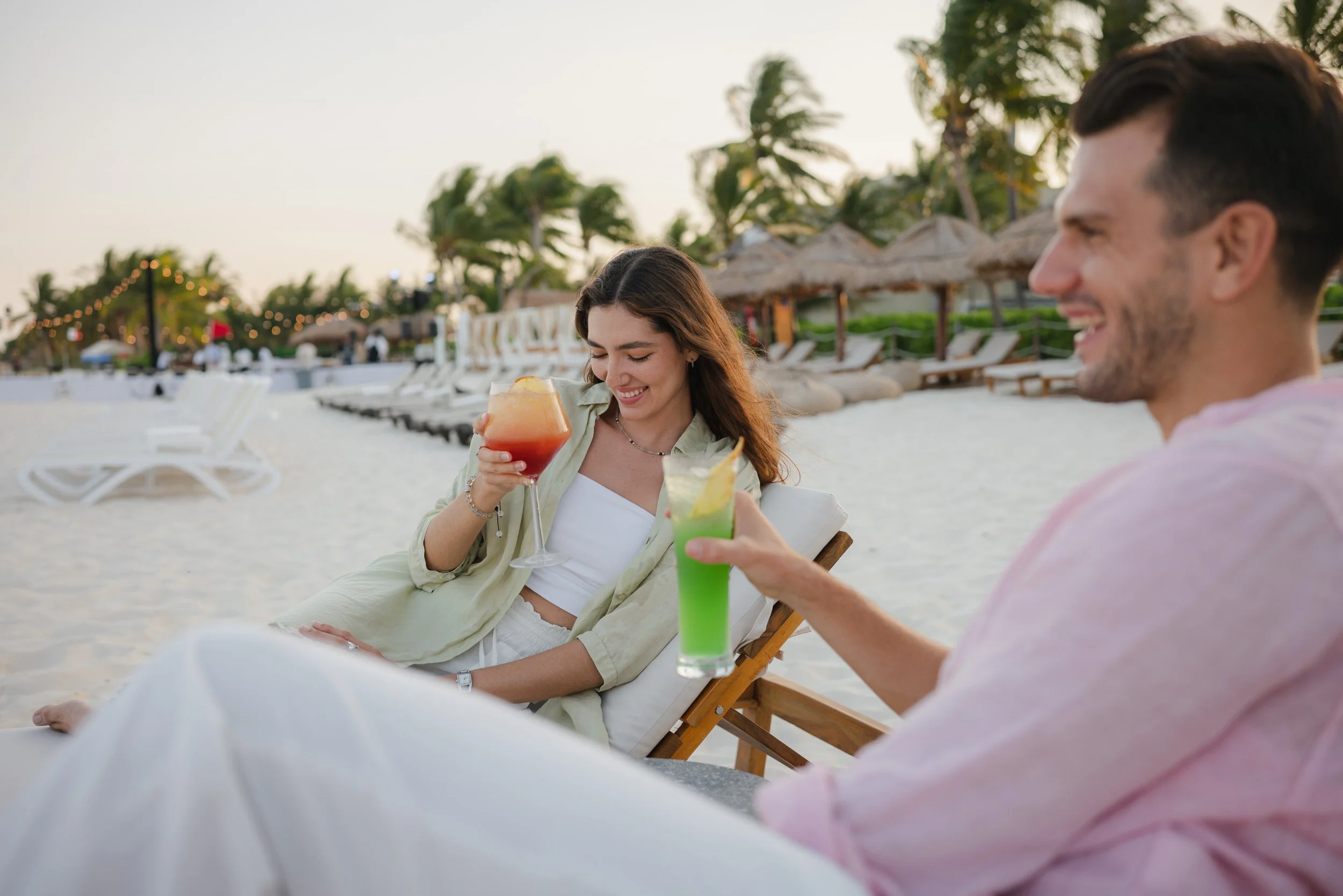 Couple enjoying cocktails on the beach at luxury Caribbean resort, David McConaghy Photography
