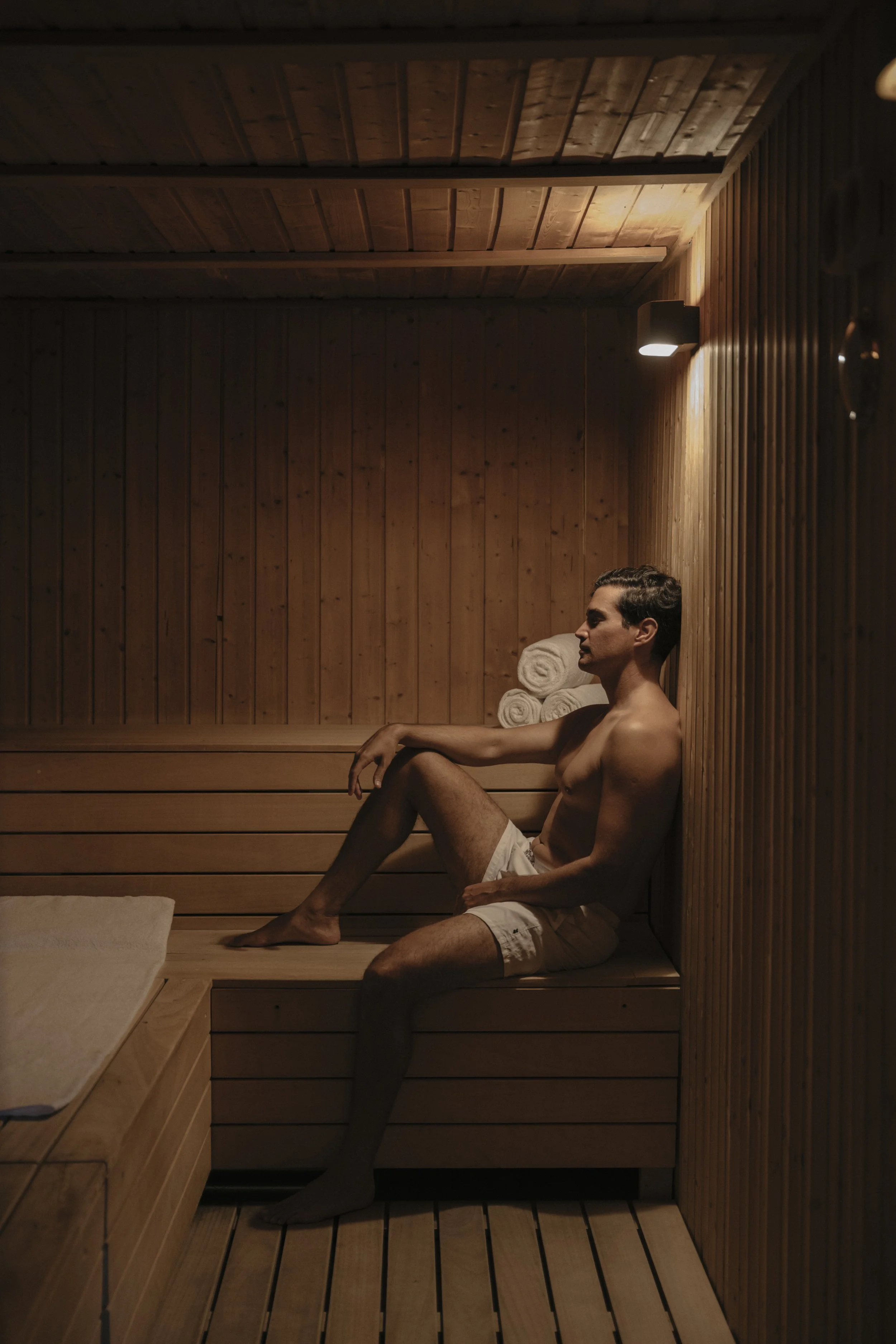 Man relaxing in luxury hotel sauna, spa photography by David McConaghy