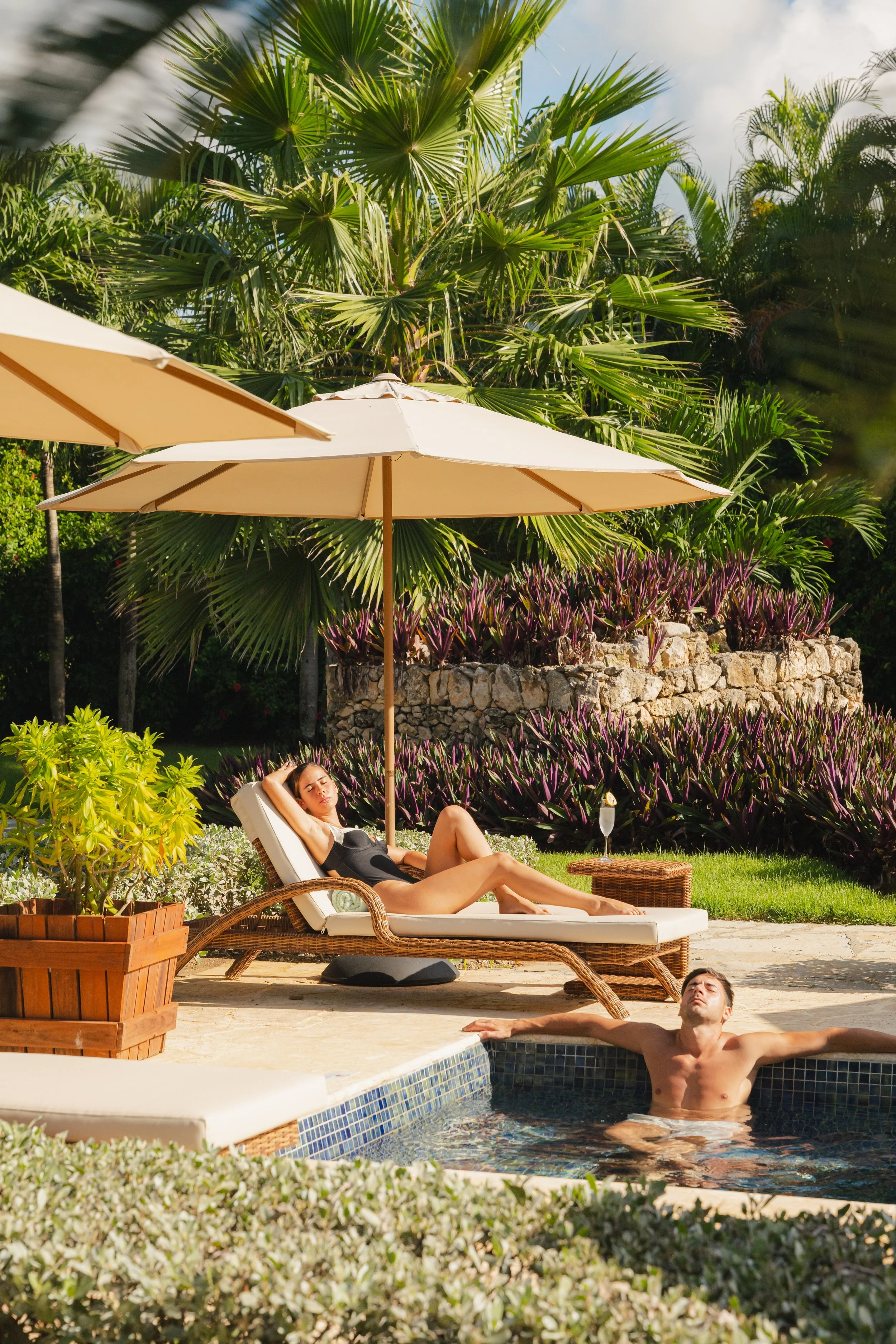 Guest relaxing on sun lounger by luxury resort pool, spa and wellness photography by David McConaghy