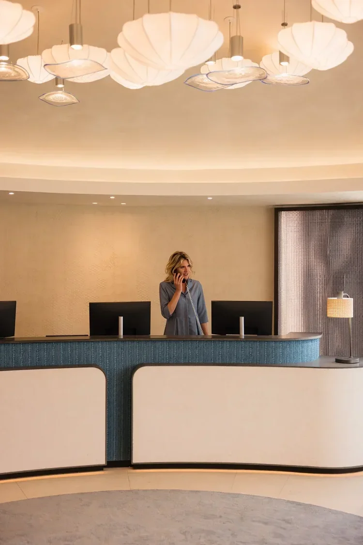 Hotel receptionist in lobby of luxury property, staff portrait photography by David McConaghy