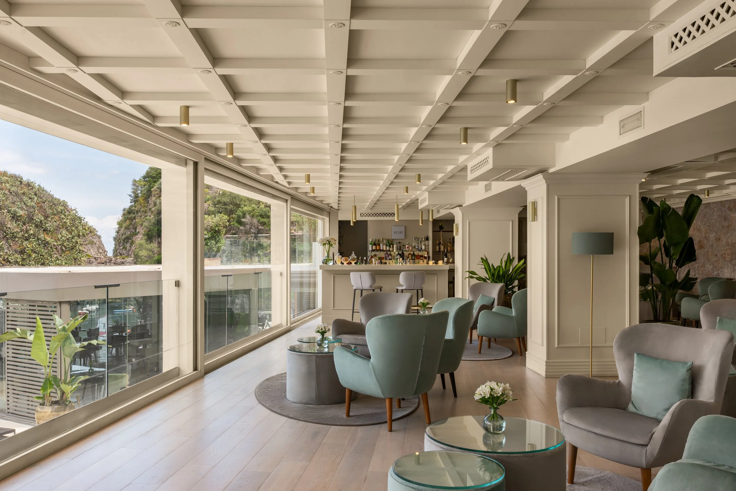 Light-filled hotel restaurant with floor-to-ceiling windows, interior photography by David McConaghy
