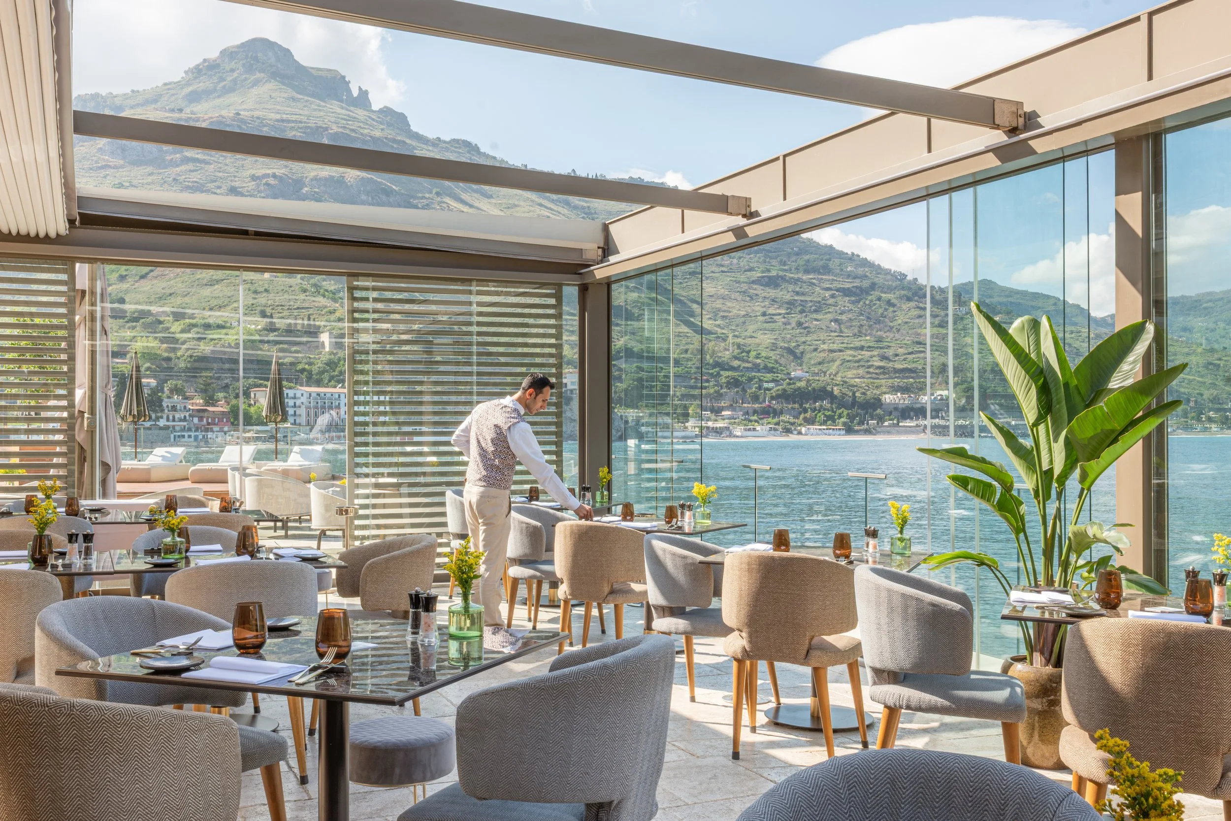 Luxury hotel restaurant with panoramic sea and mountain views, interior photography by David McConaghy