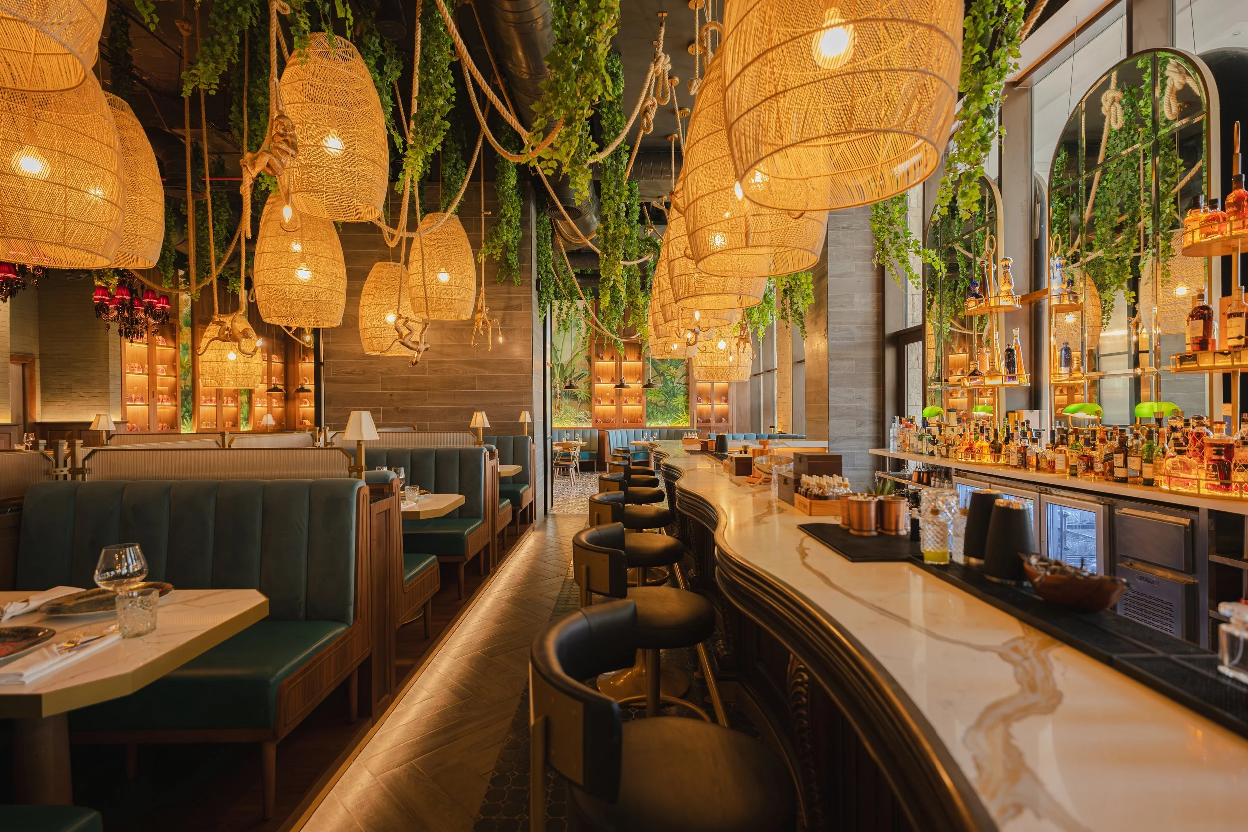 Dramatic restaurant interior with hanging lanterns and vertical garden, David McConaghy Photography