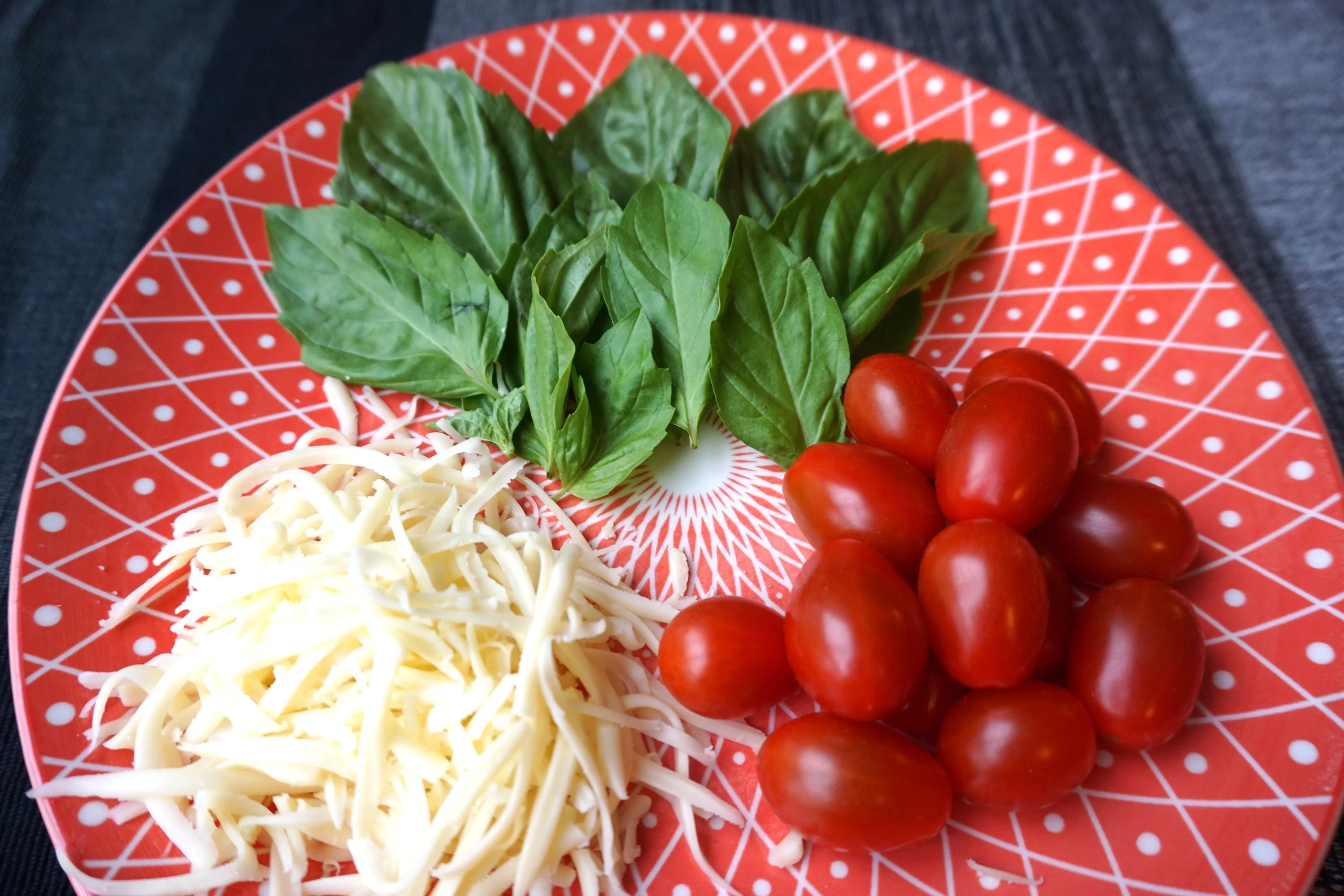 Prep your toppings! Here I have mozzarella cheese, grape tomatoes and fresh basil (Not photographed: mushrooms, salami, olives, and cheddar cheese)