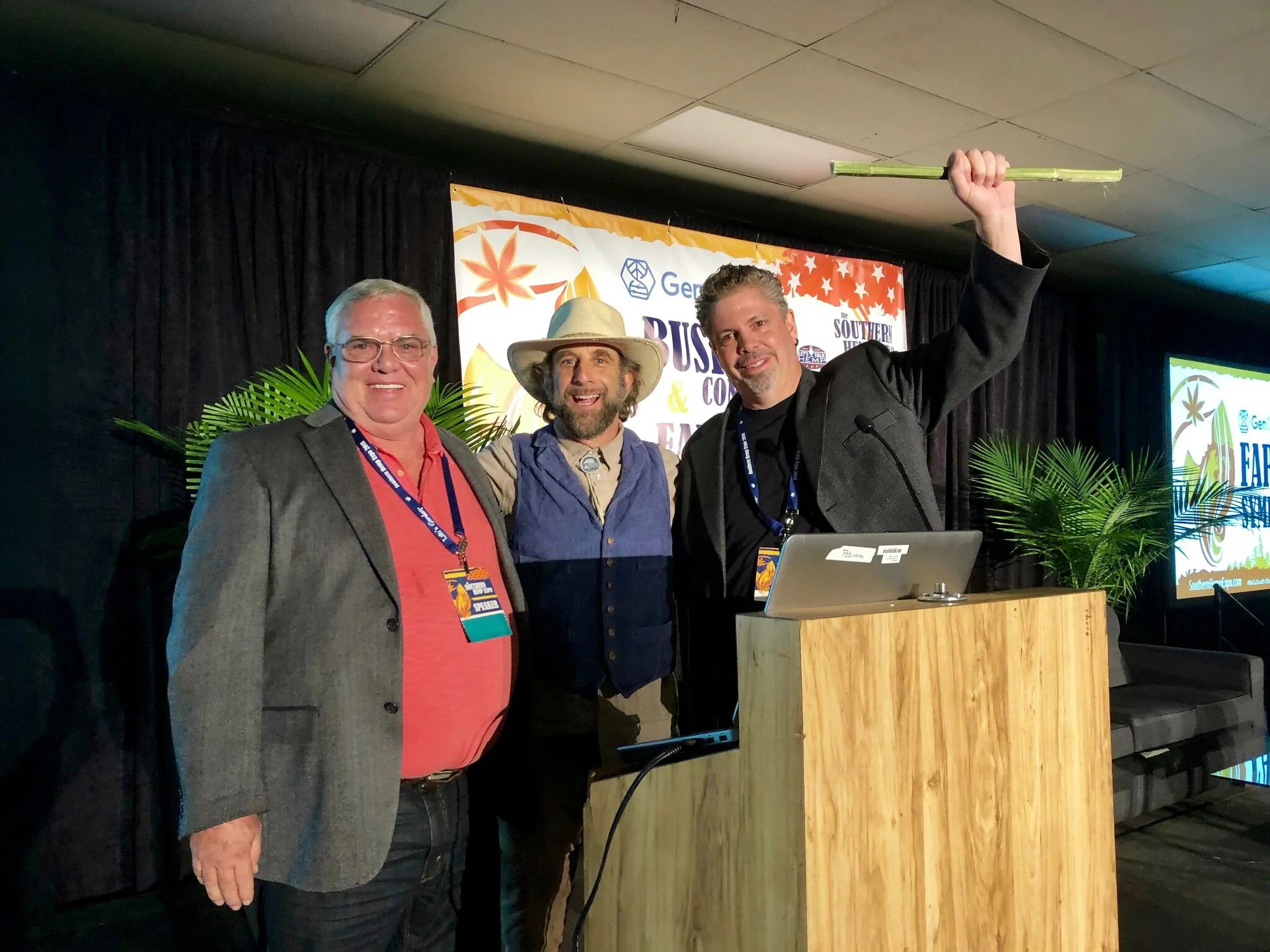 Southern Hemp Expo Co-founder Morris Beegle (right) and hemp expert and author Doug Fine (center) present a Lifetime Achievement Award to Kentucky hemp producer Craig Lee (left).