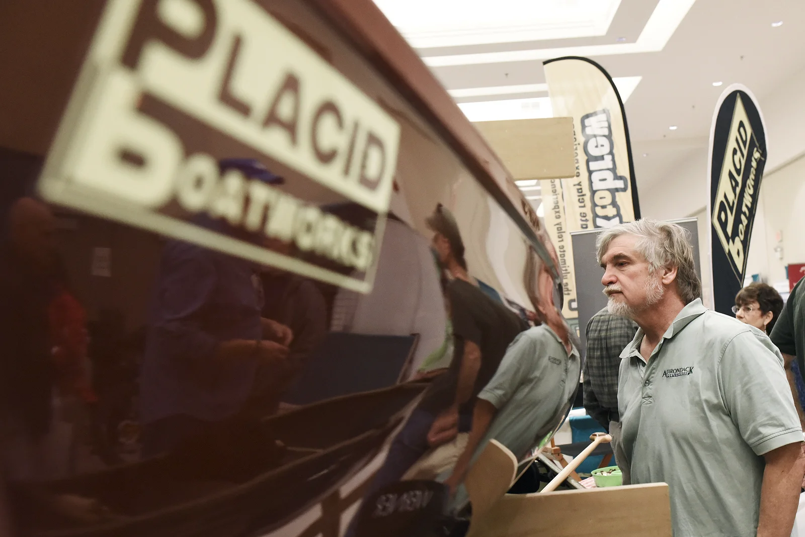 ERICA MILLER / GAZETTE PHOTOGRAPHER John Ozard, of Albany, looks at a tandem pack boat at Placid Boatworks’ booth during the Adirondack Sports Summer Expo at the Saratoga Springs City Center on Saturday afternoon, March 18, 2017.