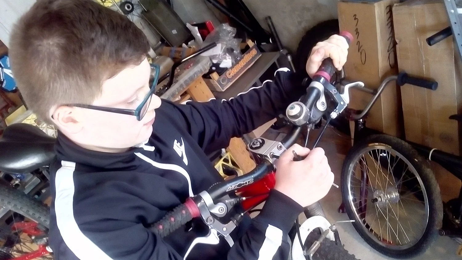 The author's son, Ewan, checks his handlebar bolts, chain ring bolts, and crank arm bolts. Jim MacNaughton