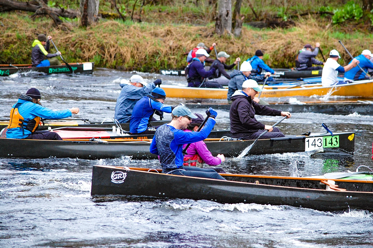 Tandem boats leave the start line at the Canton Canoe Weekend. Blanche Town