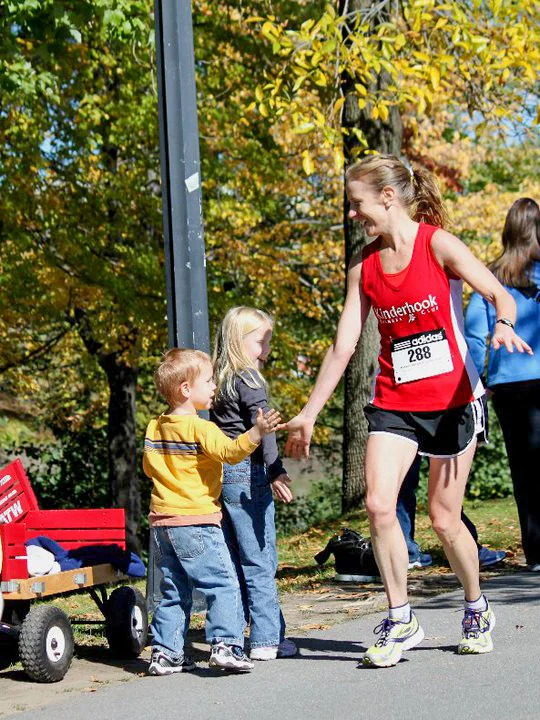 High fiving her kids at the 2010 Mohawk Hudson River Marathon finish line.
