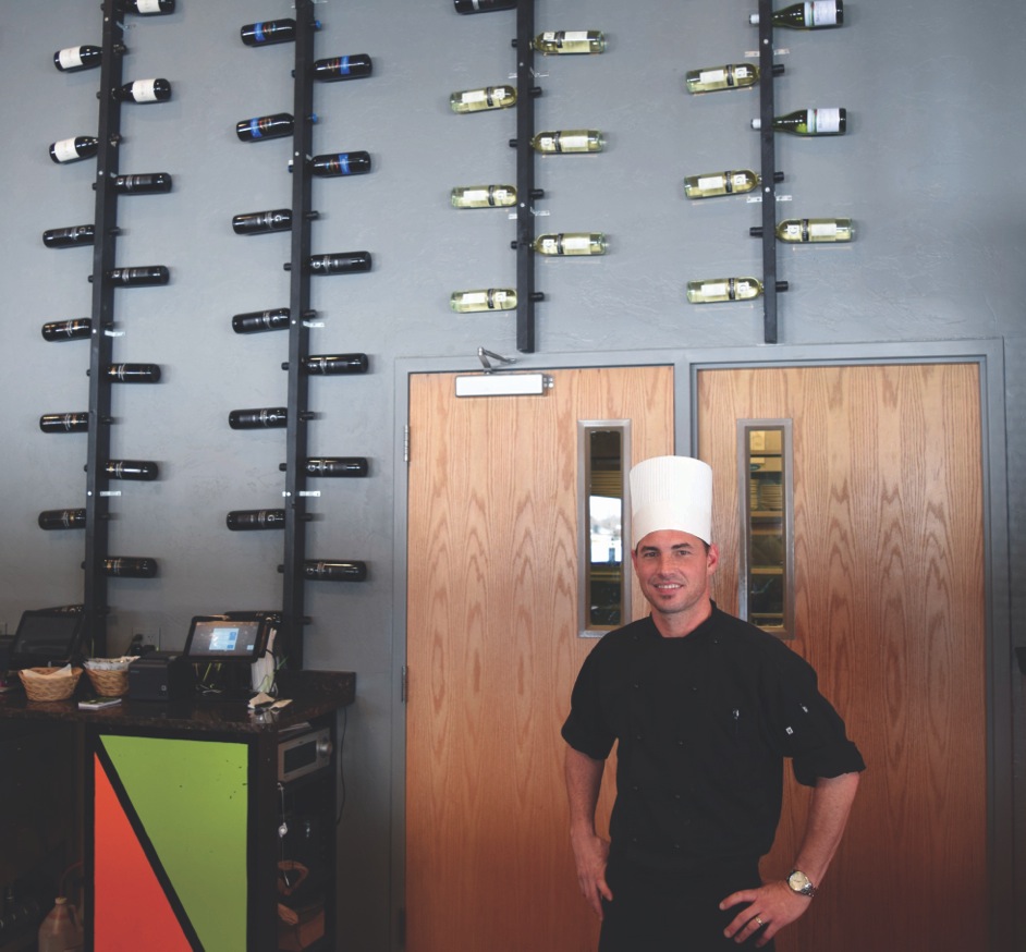 Dante Tripi, 35, stands inside Rhybax Kitchen, his new restaurant at Cattails Golf Course. The roughly 3,200 square foot dining area of Rhybax Kitchen can seat 134 guests for lunch, dinner and Sunday brunch. After the winter the patio will be able to seat more.
