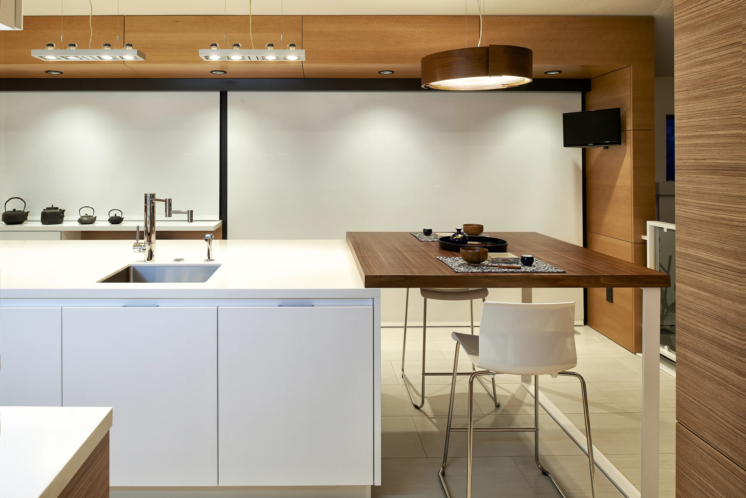 project details: white matt lacquer european textured melamine snow white krion tops matt glass back-splash veselbrand " stick " tall pulls Blum servo hardware / uppers vertical grain fir wall panels miele appliances