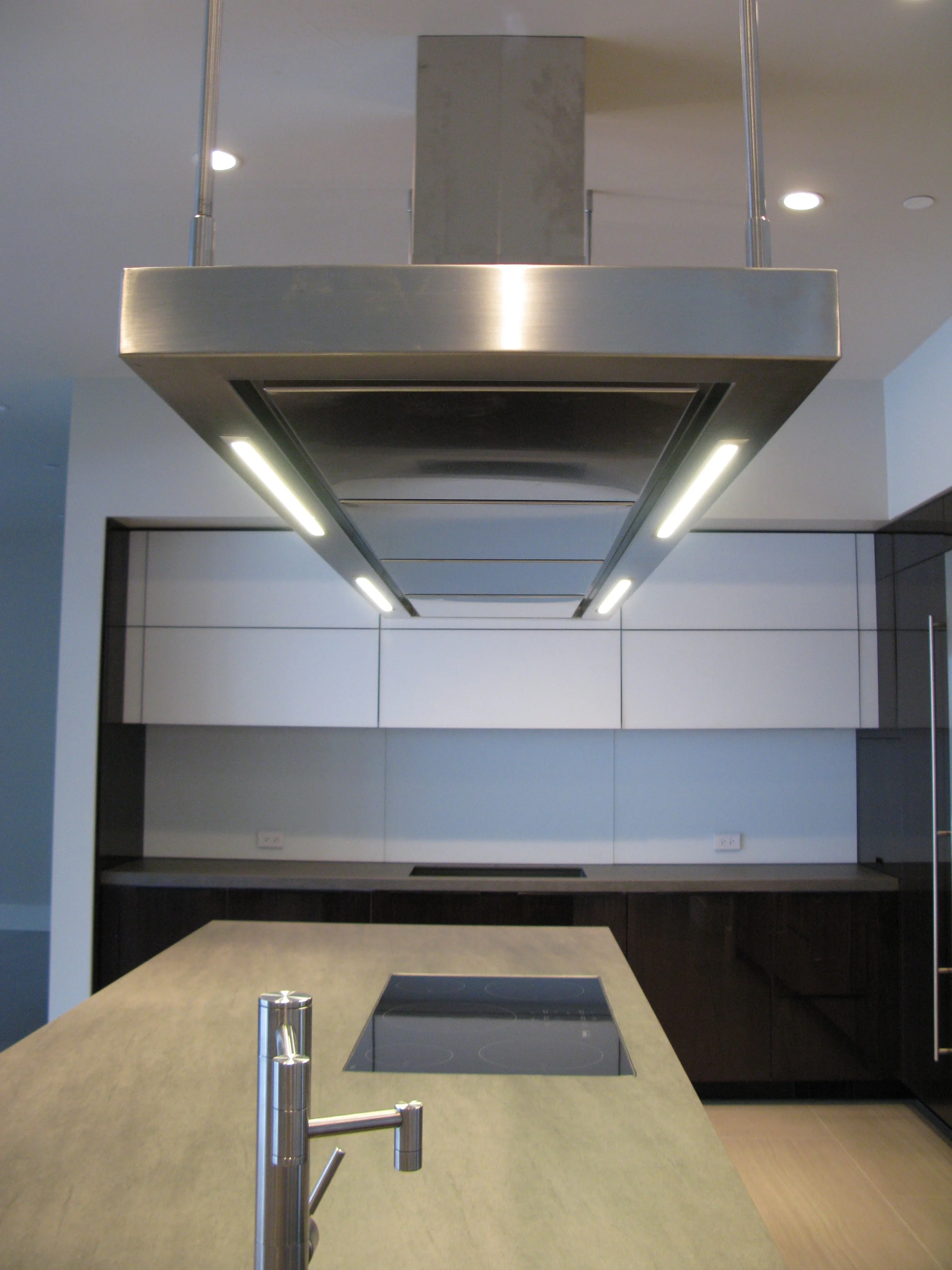 project details _______________________ high gloss walnut neolith countertops matt glass back-splash veselbrand europa air hood custom stainless fridge & freezer doors Blum servo hardware / uppers miele appliances