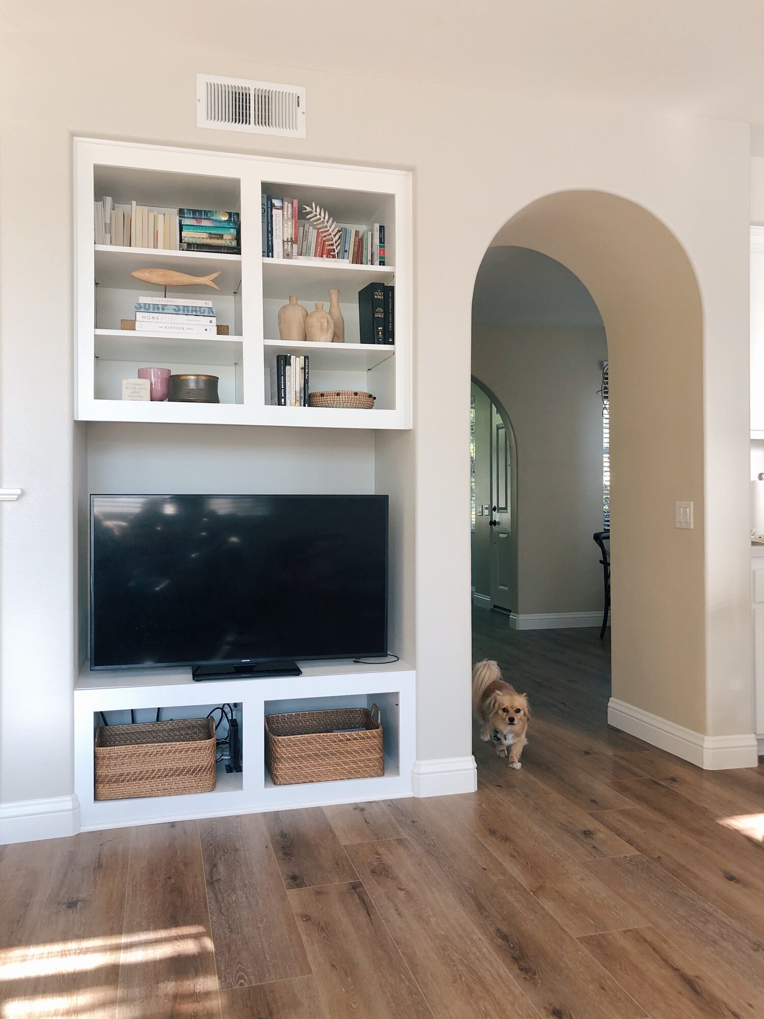 A peek at our house – I love the arched doorways, the floors, the built-ins.