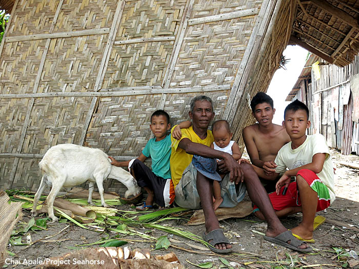 A father and his four sons sit outside their storm-damaged house. Bantayan Town. Photo: Chai Apale/Project Seahorse