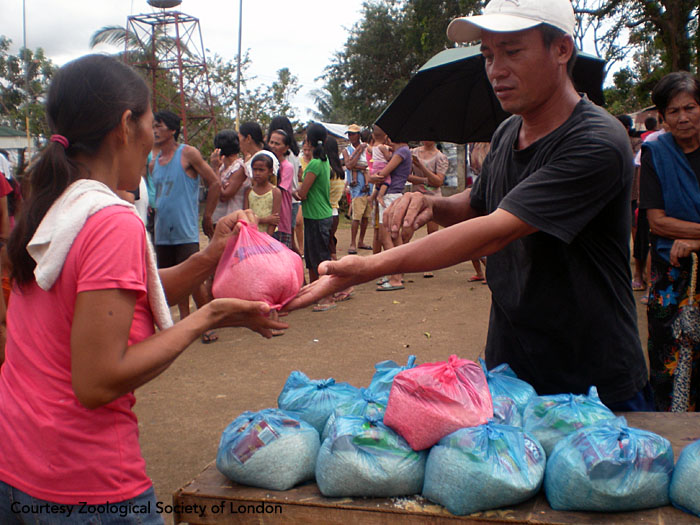 Field staff hand out relief packs to villagers. The packs contain food, clean water, soap, and essential medicines. Panay, Philippines. Photo courtesy of ZSL