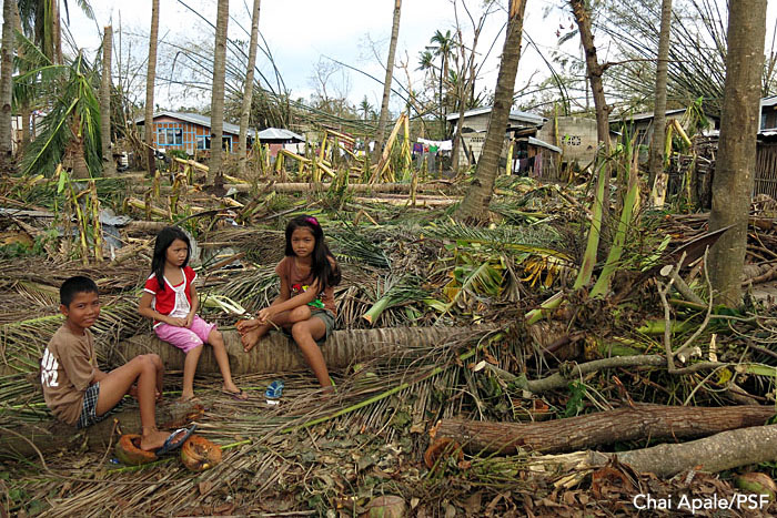 Kids rest on a knocked-down tree outside their village. Bantayan, Philippines. Photo: Chai Apale/PSF