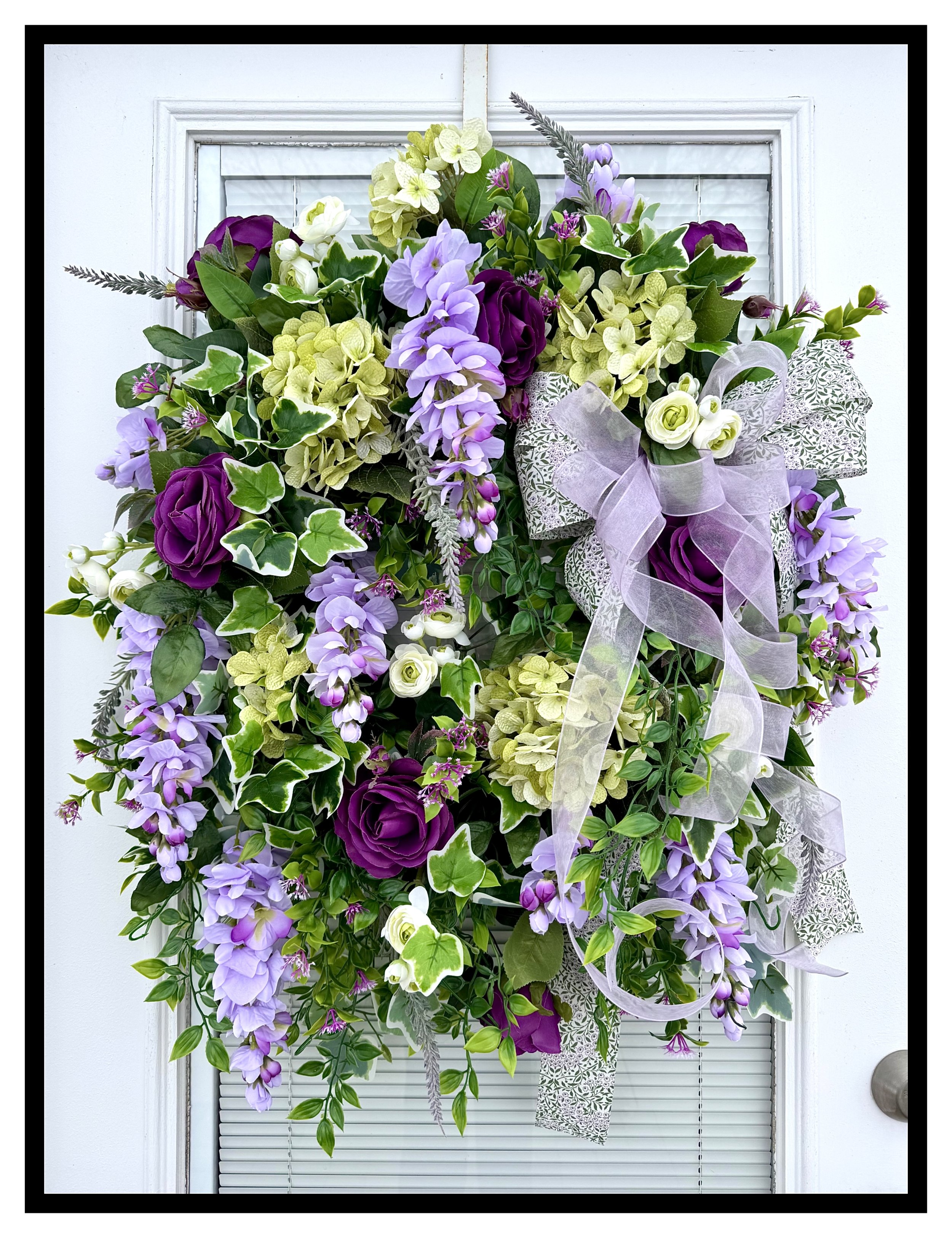 large door wreath green hydrangeas purple roses lavender wisteria