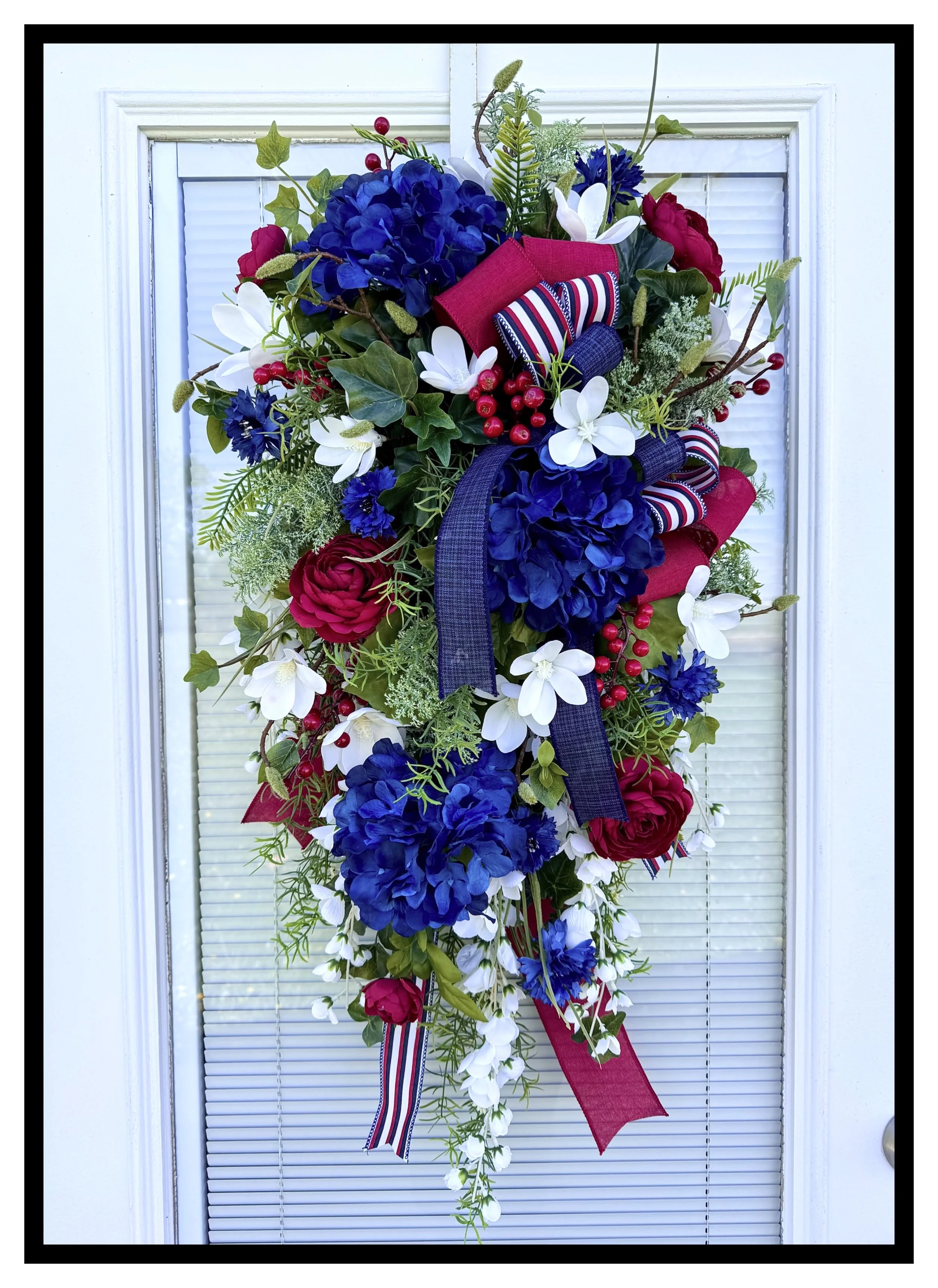 american patriotic floral door swag with blue hydrangeas and white magnolias