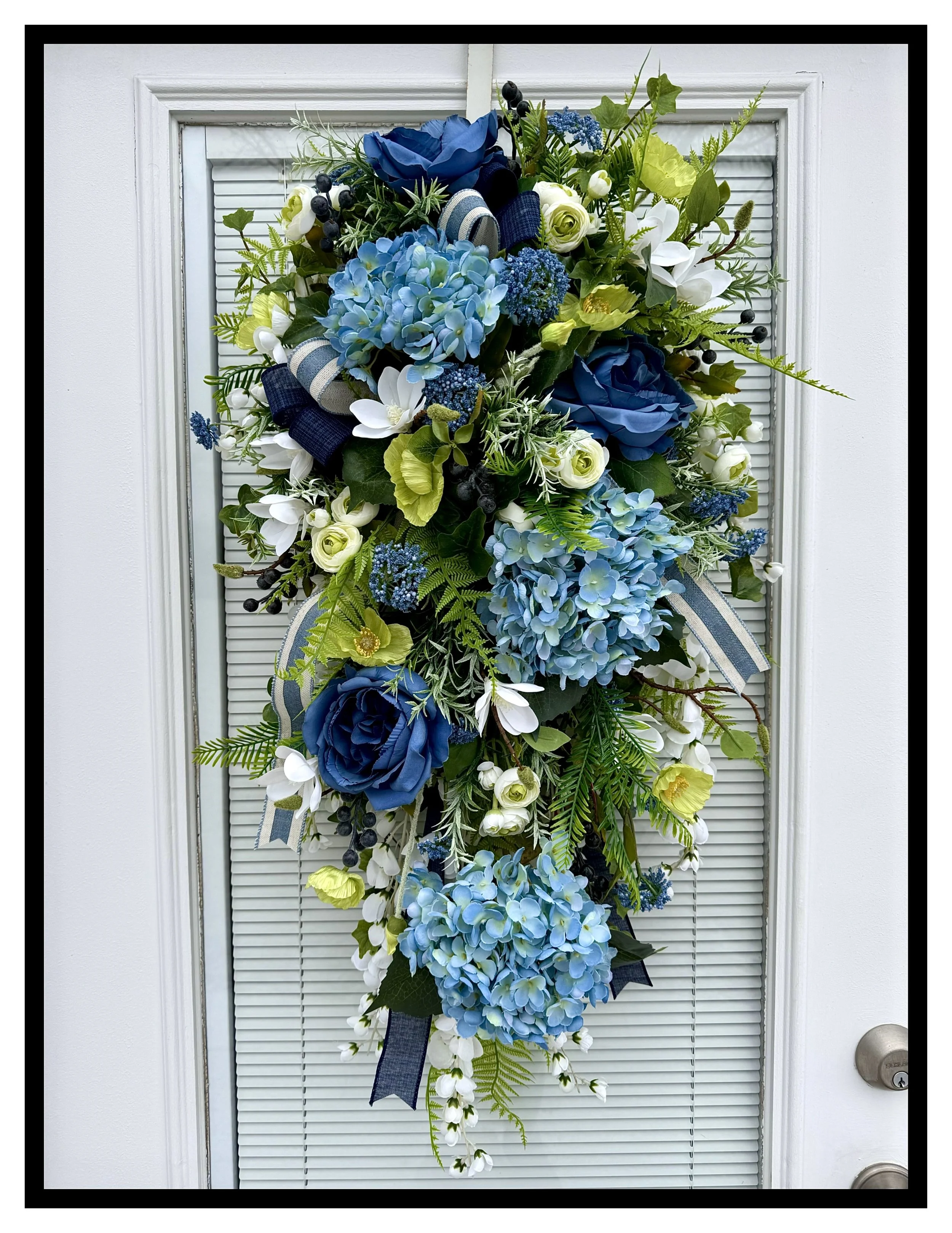 vertical door swag blue hydrangeas rose white mini magnolias green poppies berries ivy fern