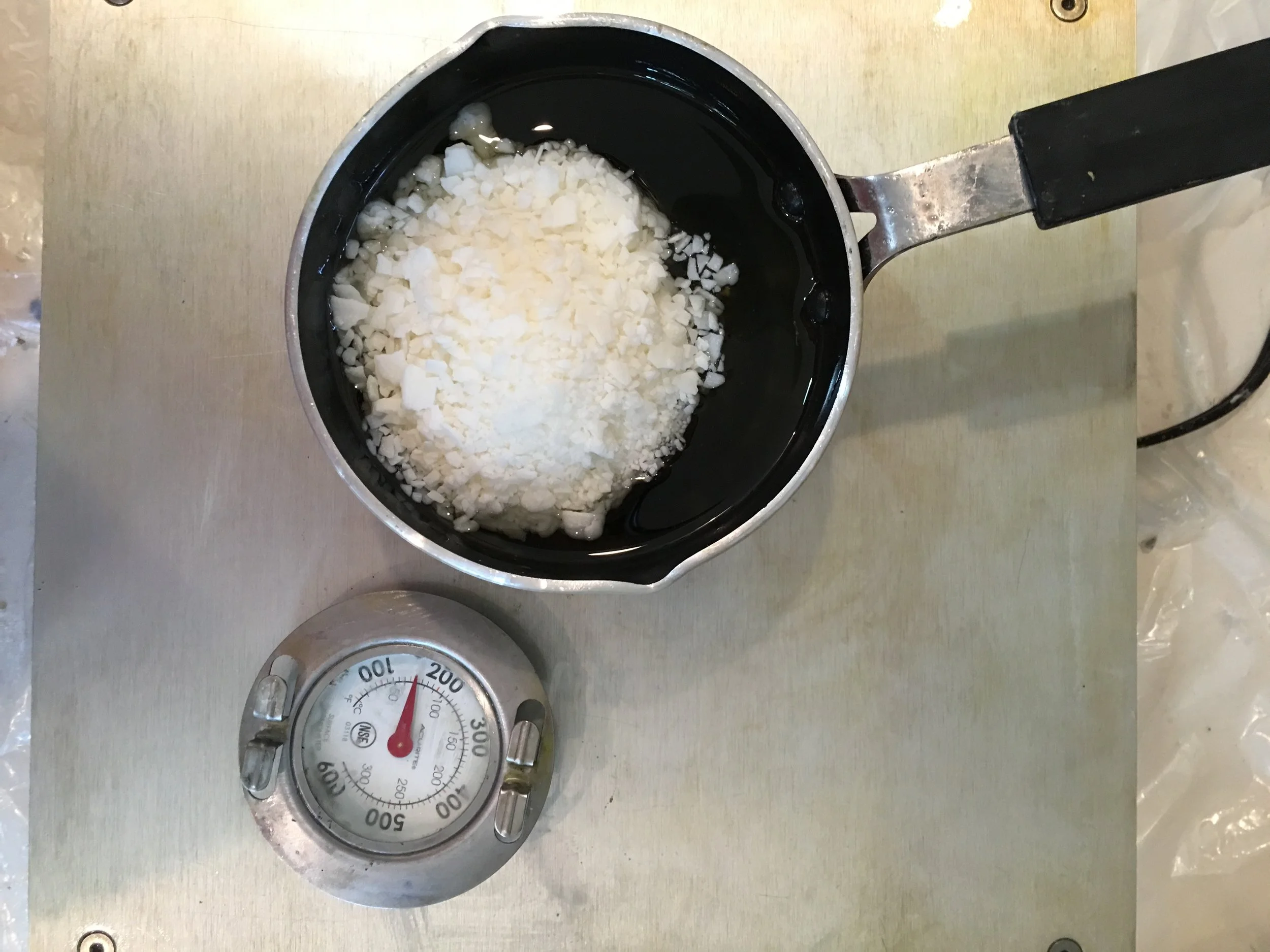 I used my encaustic wax melting setup to melt several colors at once - it contains a aluminum heating top with a electric heating element underneath. 