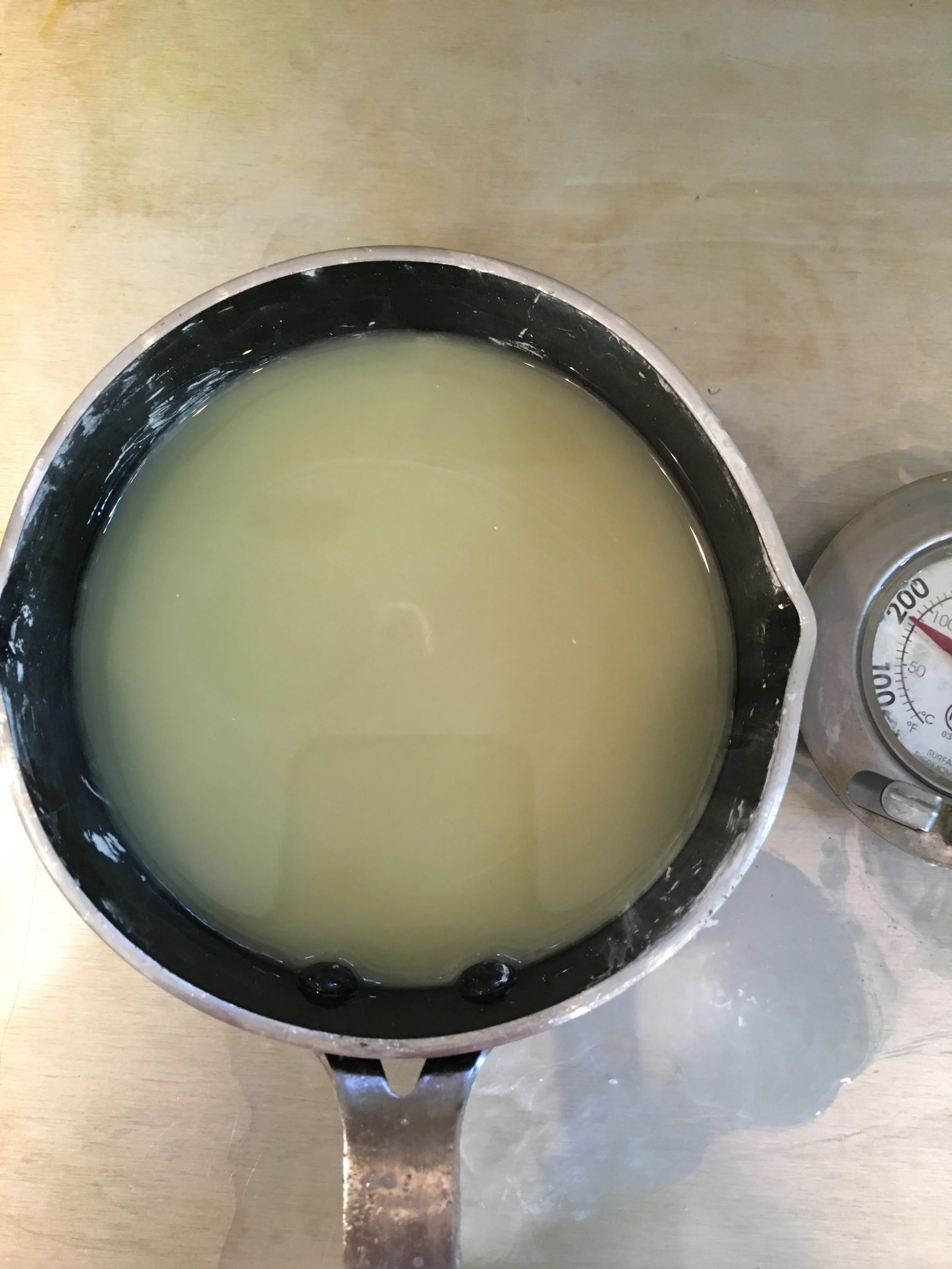 Yellow and blue to make a pale green - more blue will darken the color. Go slow adding the liquid blue until you've achieved the green color you're looking for when using wax candle color dye. 