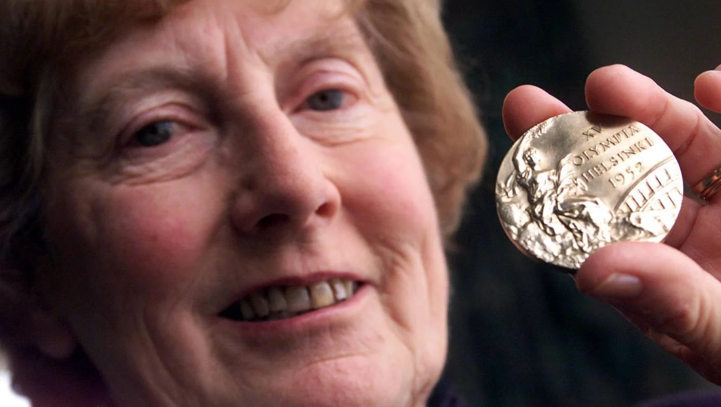 Yvette Corlett (nee Williams), pictured in 2002 with her 1952 Helsinki Games gold medal.