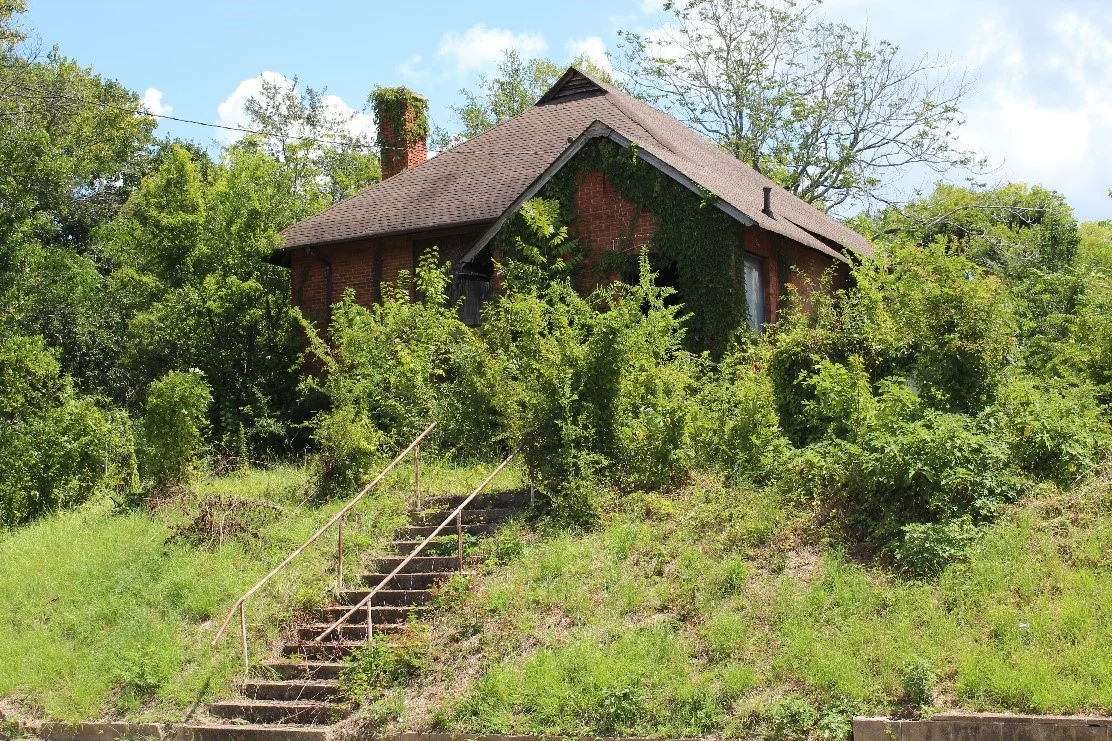 This building was originally the First Congregational Church built in 1917 and was a historically African American church in the Pleasant Hill neighborhood. The congregation was established in 1868 and immediately began working the “higher development and improvement” of Macon’s black community. The church had very close ties with Ballard Hudson Normal School because of their mutual goals to increase education and civic-mindedness in African Americans, despite the harsh laws of segregation throughout the area at that time. The First Congregational Church remained in this building until 1991. The structure was then vacant between 1992 and 1997, before it was purchased by the Booker T. Washington Foundation, whose main community center was then located across the street. The community center has used the building for everything from a daycare to a dance studio known as the Bobby Jones Center for the Performing Arts since purchasing it in 1998. However, they shuttered the building in the last few years because they do not have the funds to make some necessary repairs. The threat to the Bobby Jones Performing Arts Center is demolition by neglect. The Booker T. Washington Foundation is no longer active and does not have the personnel or funds to look after the structure. The solution for the Bobby Jones Performing Arts Center is redevelopment by a sensitive new owner. Since the building is currently owned by a moribund non-profit, it will be difficult for a new owner to acquire. Historic Macon is actively seeking solutions to this issue and welcomes any information about its ownership or possible ways for a new owner to buy the building.