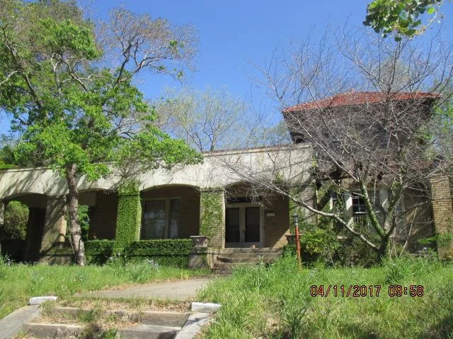 The Guy E. Paine House is a contributing property in the Cherokee Heights National Register of Historic Places District. The house was built circa 1912 in Italian Renaissance style as part of the original development of the Cherokee Heights neighborhood and has had a number owner-occupants in its lifetime. The first owner was Guy E. Paine, who was recruited to Macon by Henry C. Bagley to work for the Penn Mutual Insurance Company. Although Paine had visited Macon on business before, he had been living in Chicago prior to coming back down South. Paine had an illustrious career in Macon. He served as the President of the Chamber of Commerce in 1915 and 1916, President of Rotary and spearheaded Rotary’s military committee. Paine and the committee were instrumental in getting the infrastructure improvements necessary for Camp Wheeler. The Paine family owned the house until 1971. The house has been foreclosed on twice since 1998. A 2013 image shows the property in at least fair condition, but it is now heavily overgrown and shows signs of neglect. The solution for this property is purchase and rehabilitation by a sensitive new owner. As a contributing property in the Cherokee Heights National Register Historic District, it is eligible for preservation incentives to assist with its rehabilitation. HMF looks forward to working with the property owner to preserve this unique house. Photo courtesy of the Macon-Bibb County Tax Assessor.