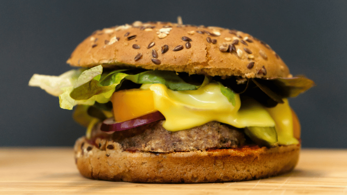 healthy takeaways - wholegrain burger with grilled patty, melted cheese and lots of colourful salad vegetables