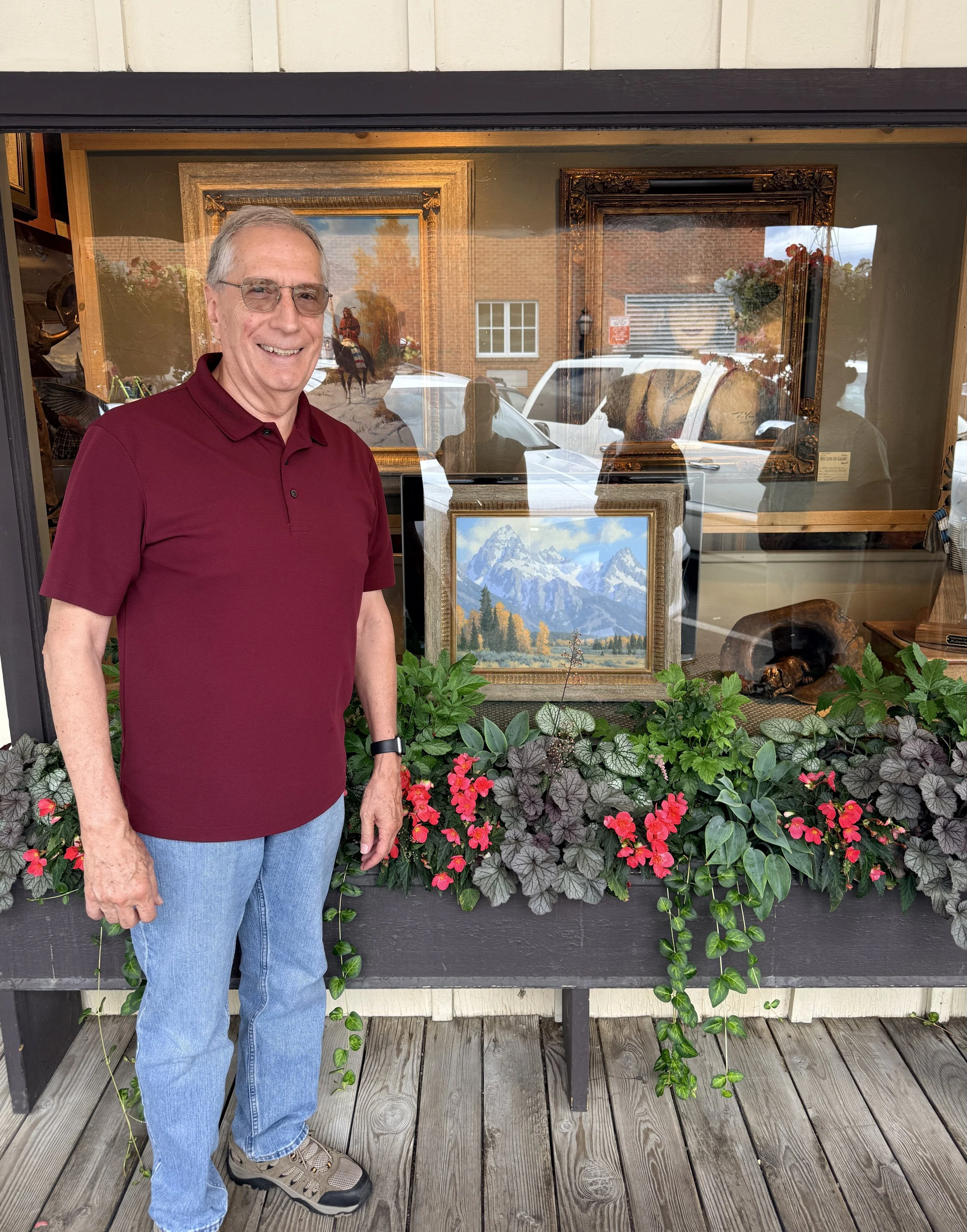 My dad, Michael Hadley, standing in front of his painting of the Tetons at the West Lives On gallery front window.