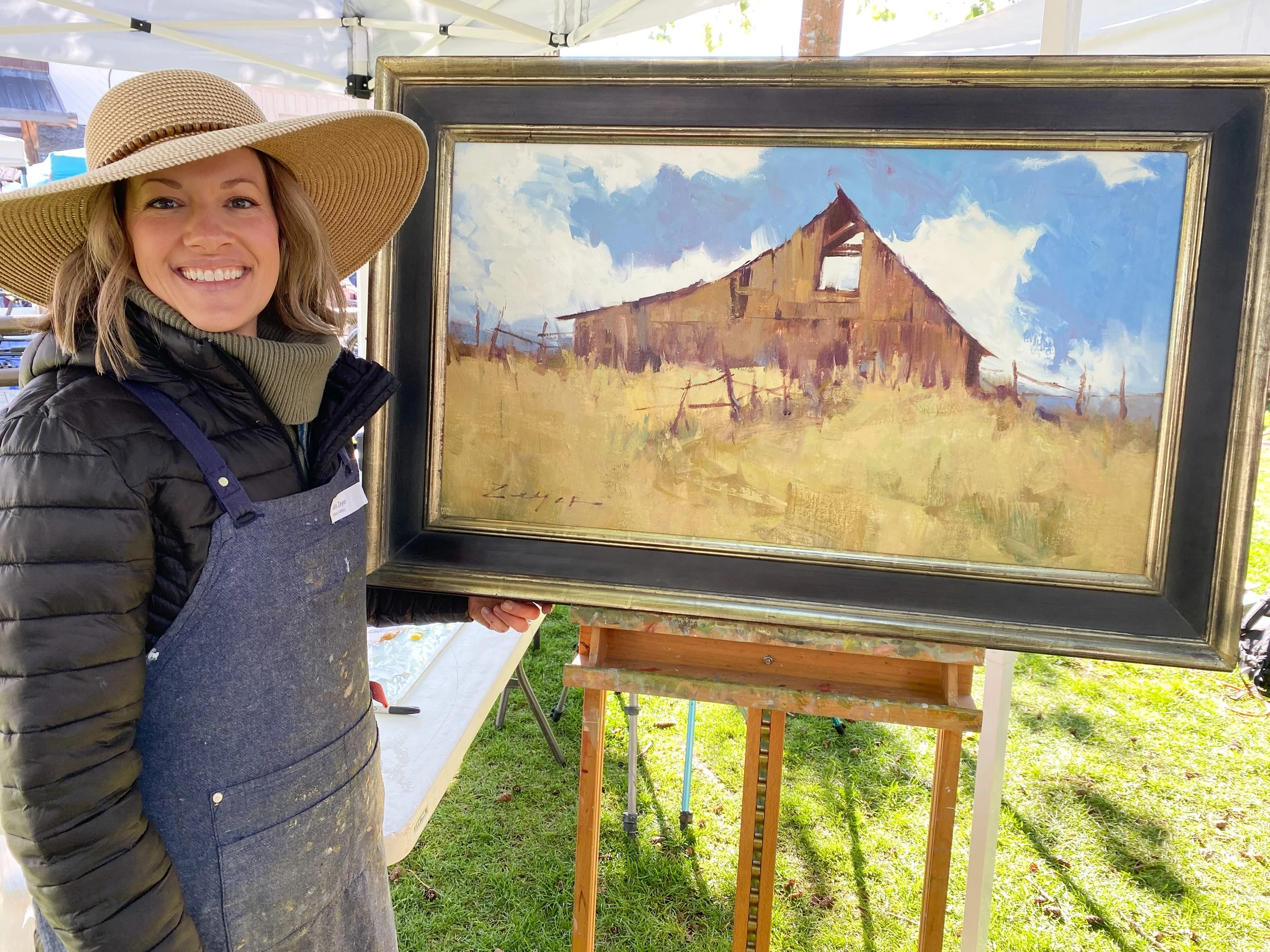 Allie Zeyer at the Jackson Hole QuickDraw 2023 with her painting "Rustic Charm Under and Azure"