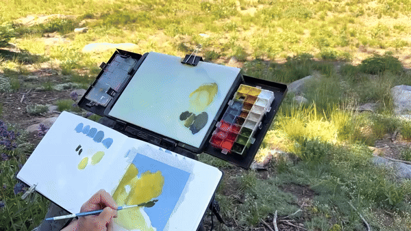 Timelapse of Allie Zeyer painting landscapes plein air in gouache in Idaho
