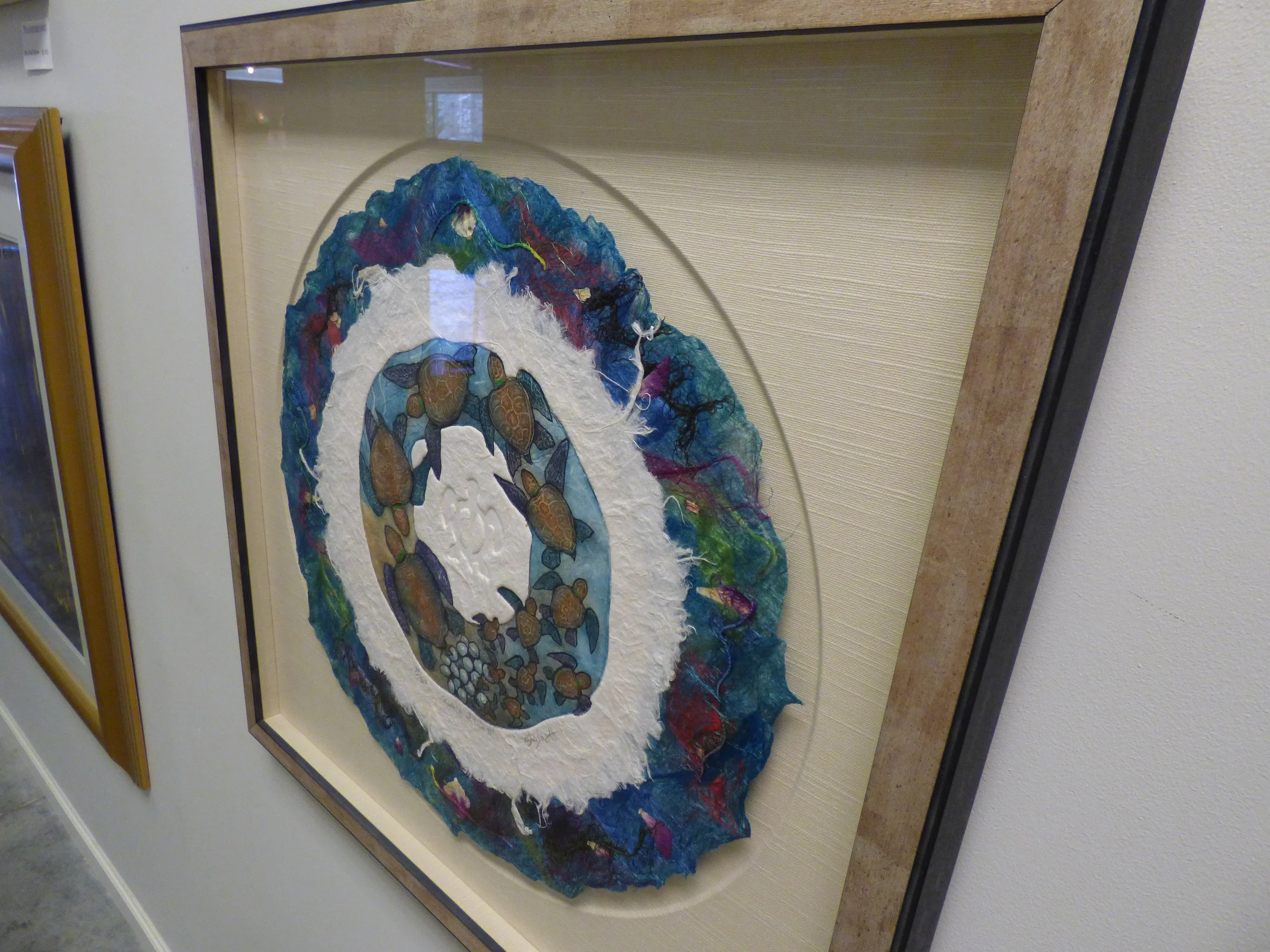 This stunning handmade paper artwork was brought back from Hawaii by Prairiebrooke customers. The framing chosen is as unique as the piece itself. 