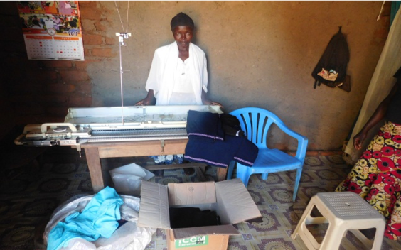 Janet posing with some of her products in her shop in Yumbe Town Council. 