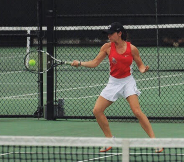 Action shot of Caroline playing collegiate tennis for Rhodes College!