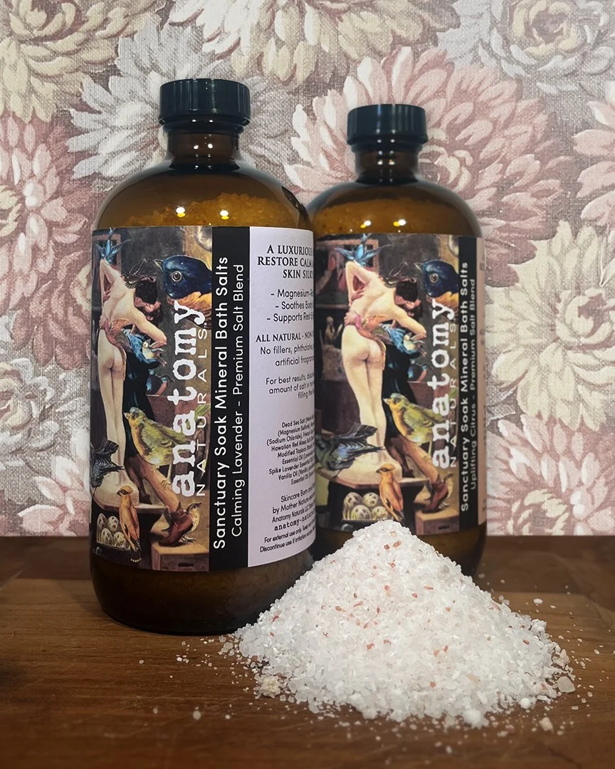 Sanctuary Soak bath salts in glass bottles with mineral salts poured out for display – natural skincare for sore muscles